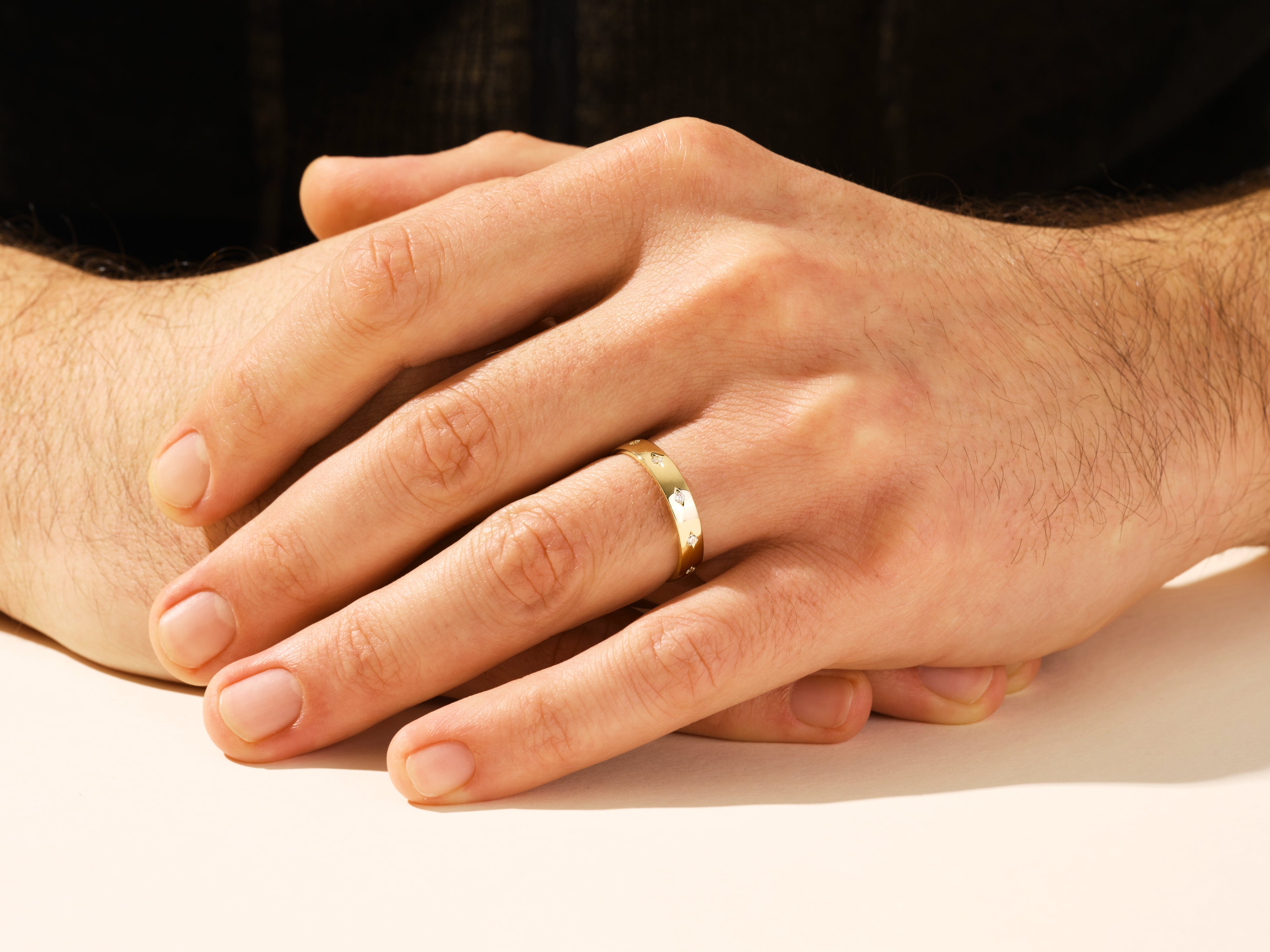 Gold ring with diamonds on a man's hand, jewelry