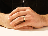 Men's gold wedding band with diamond accent from jewelry firm