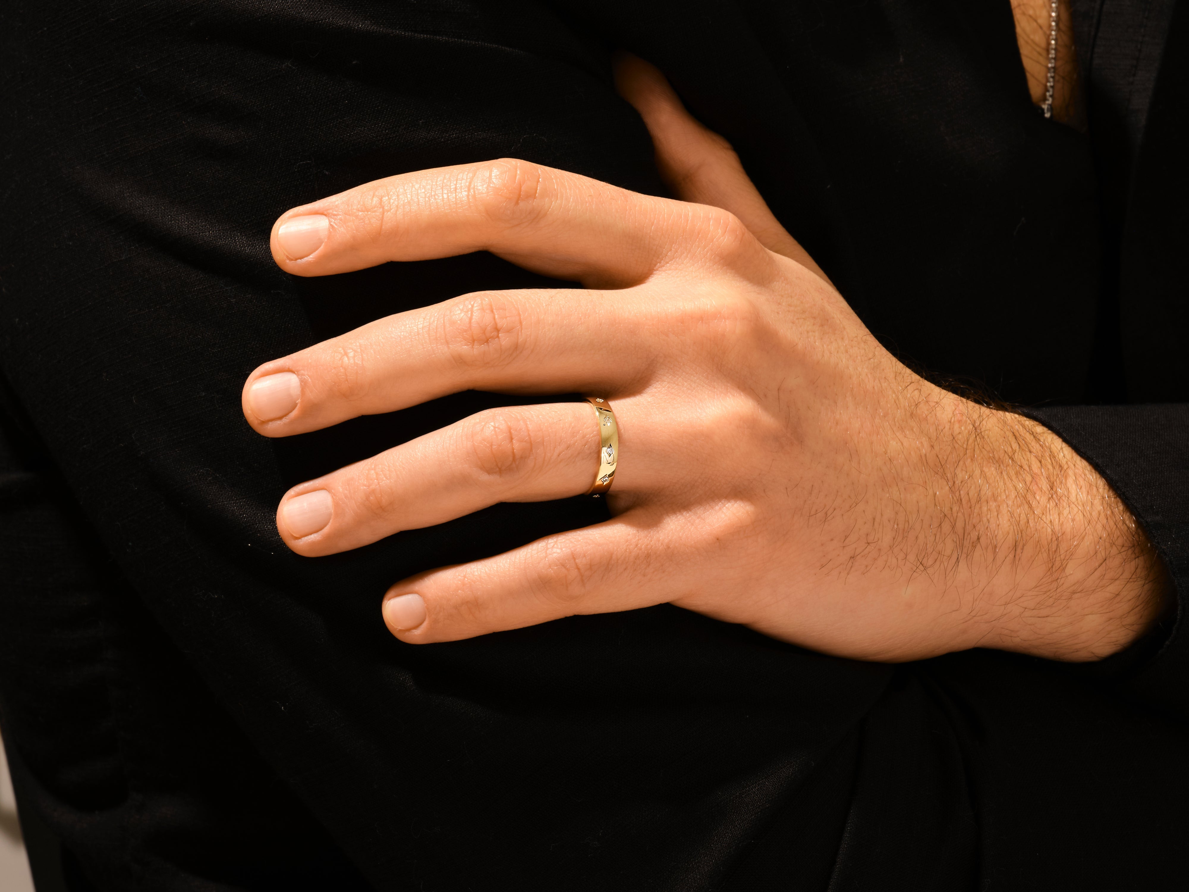 Gold ring with diamonds on a man's finger, jewelry