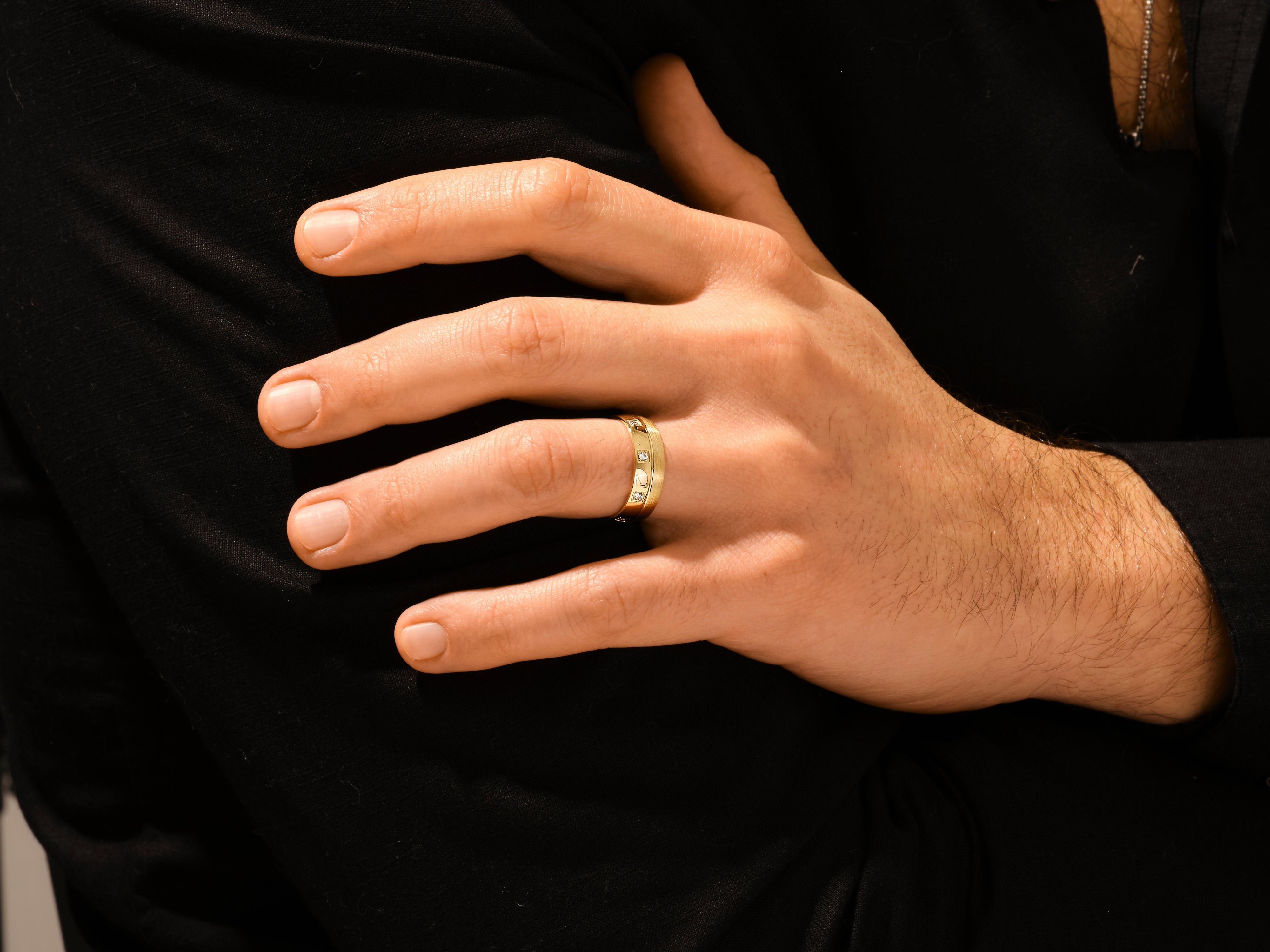 Men's gold diamond ring on hand, luxury jewelry