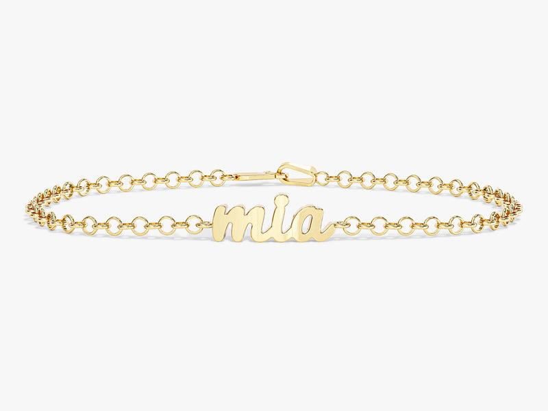 Gold name bracelet with "mia" script charm