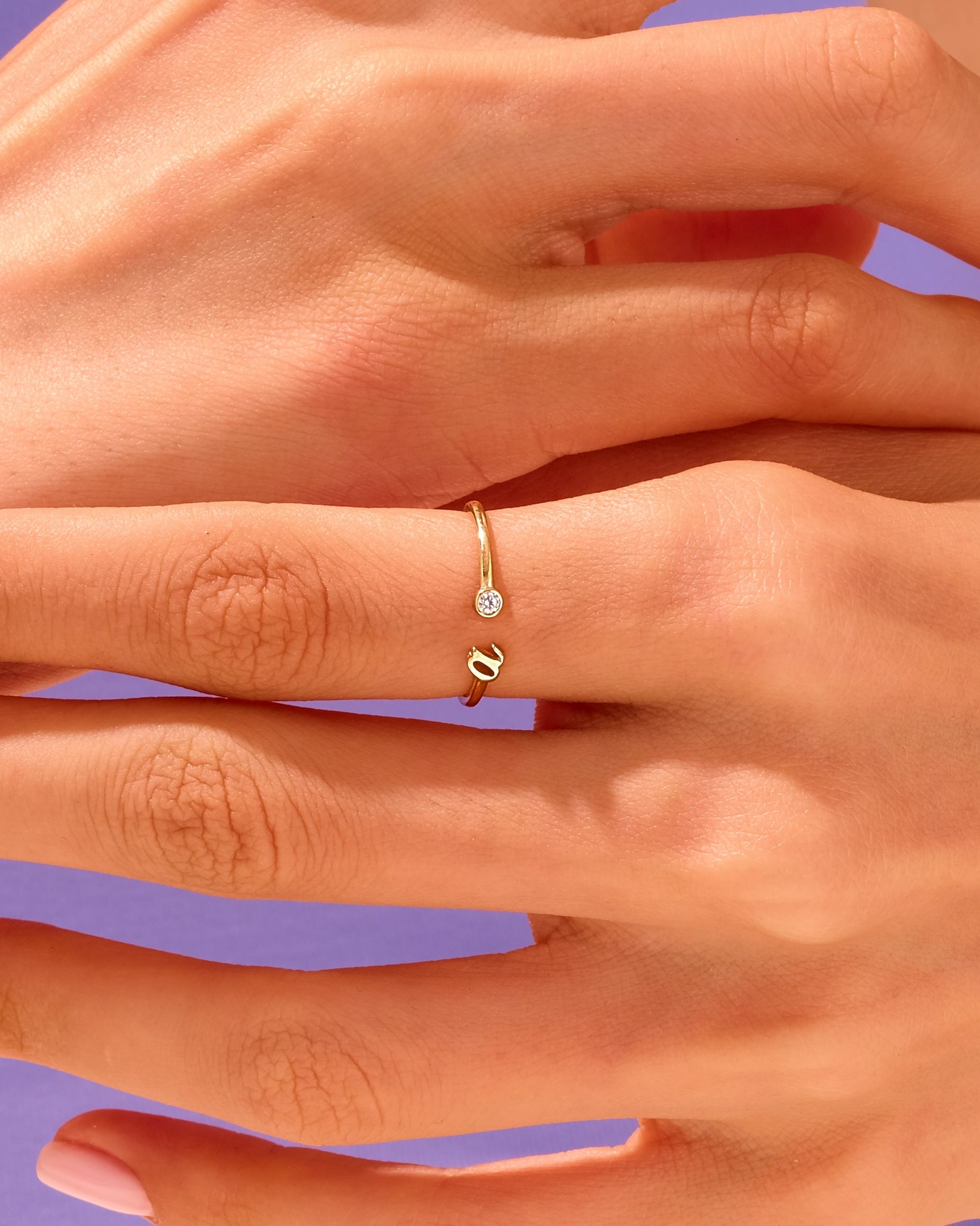 Delicate gold ring with diamond accent on hand