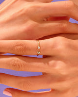 Delicate gold ring with diamond accent on hand