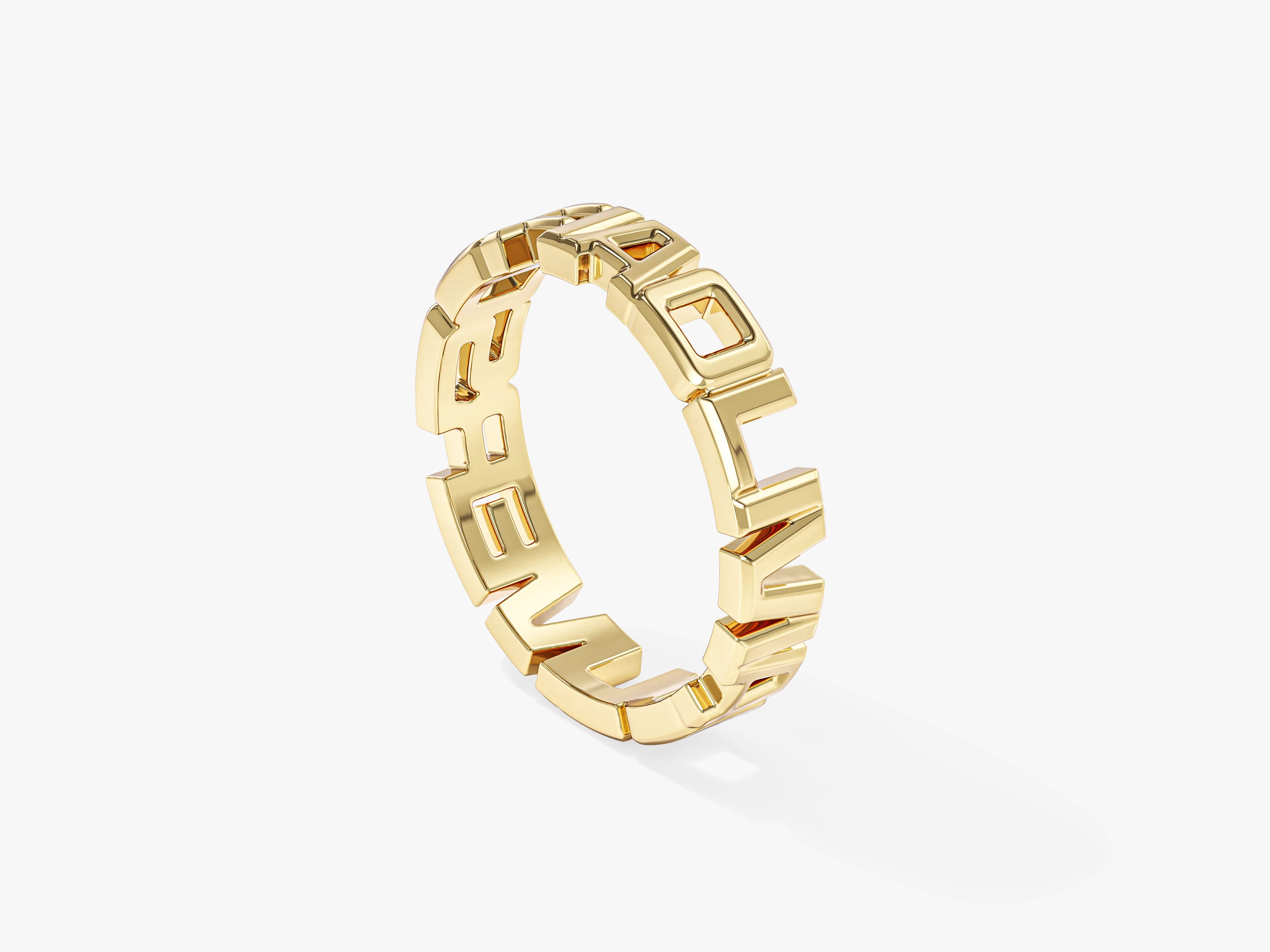 Gold ring with cutout letters spelling "LOVE"