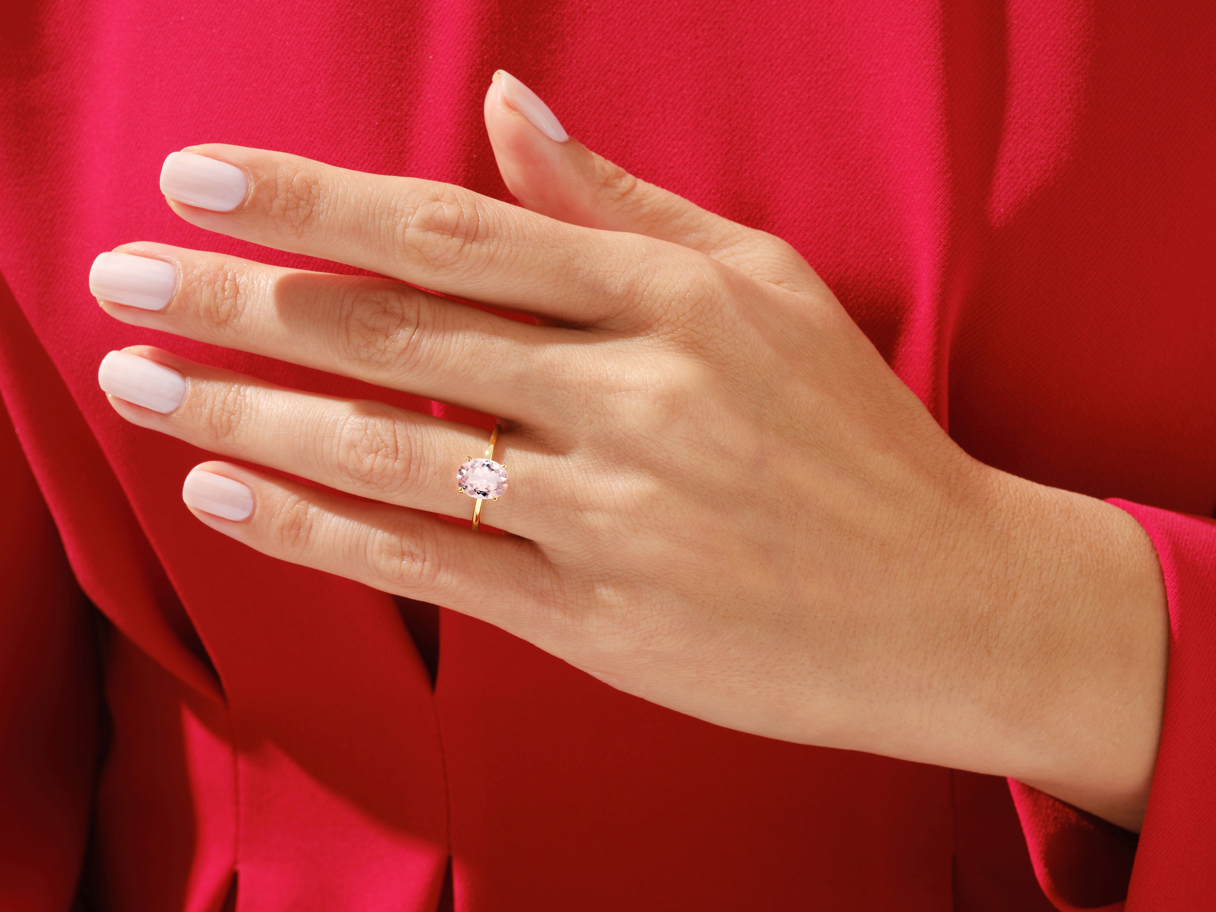 Oval pink gemstone ring on a woman's hand