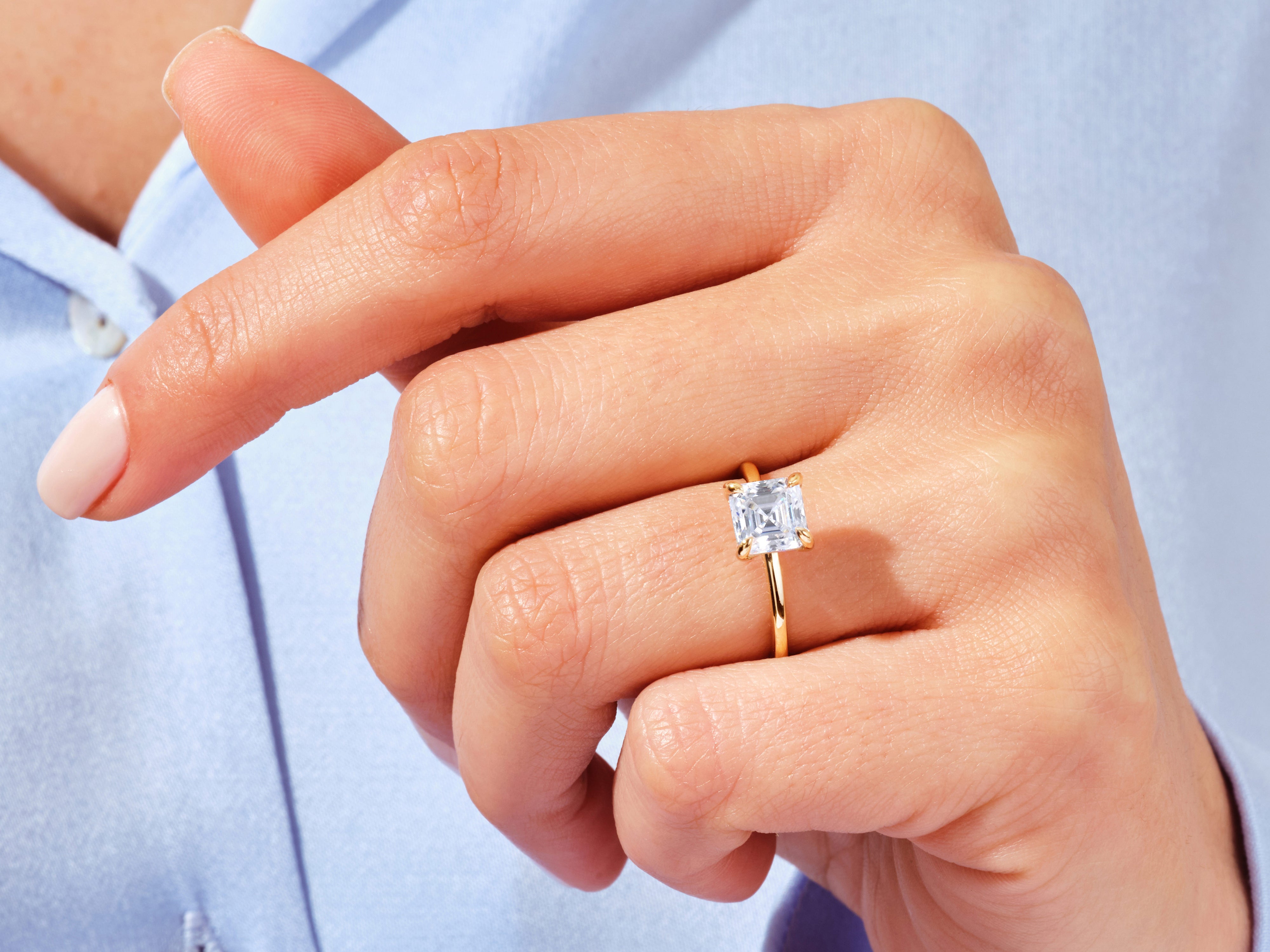 Emerald cut diamond ring on a woman's hand