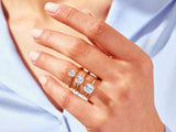 Gold rings with emerald cut diamonds on a hand
