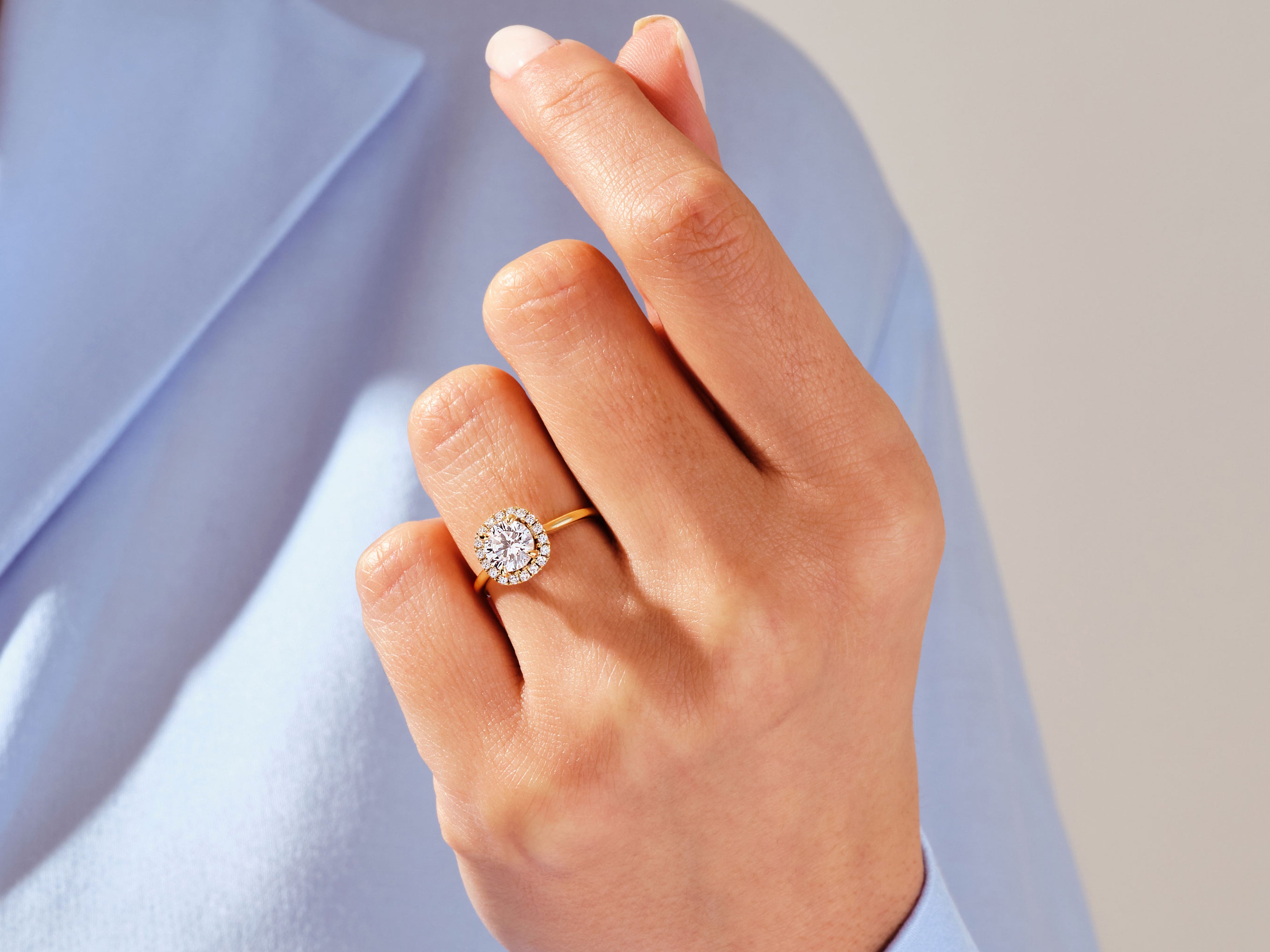 Diamond halo engagement ring on a woman's hand