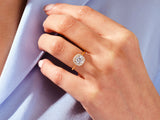Gold diamond halo engagement ring on hand