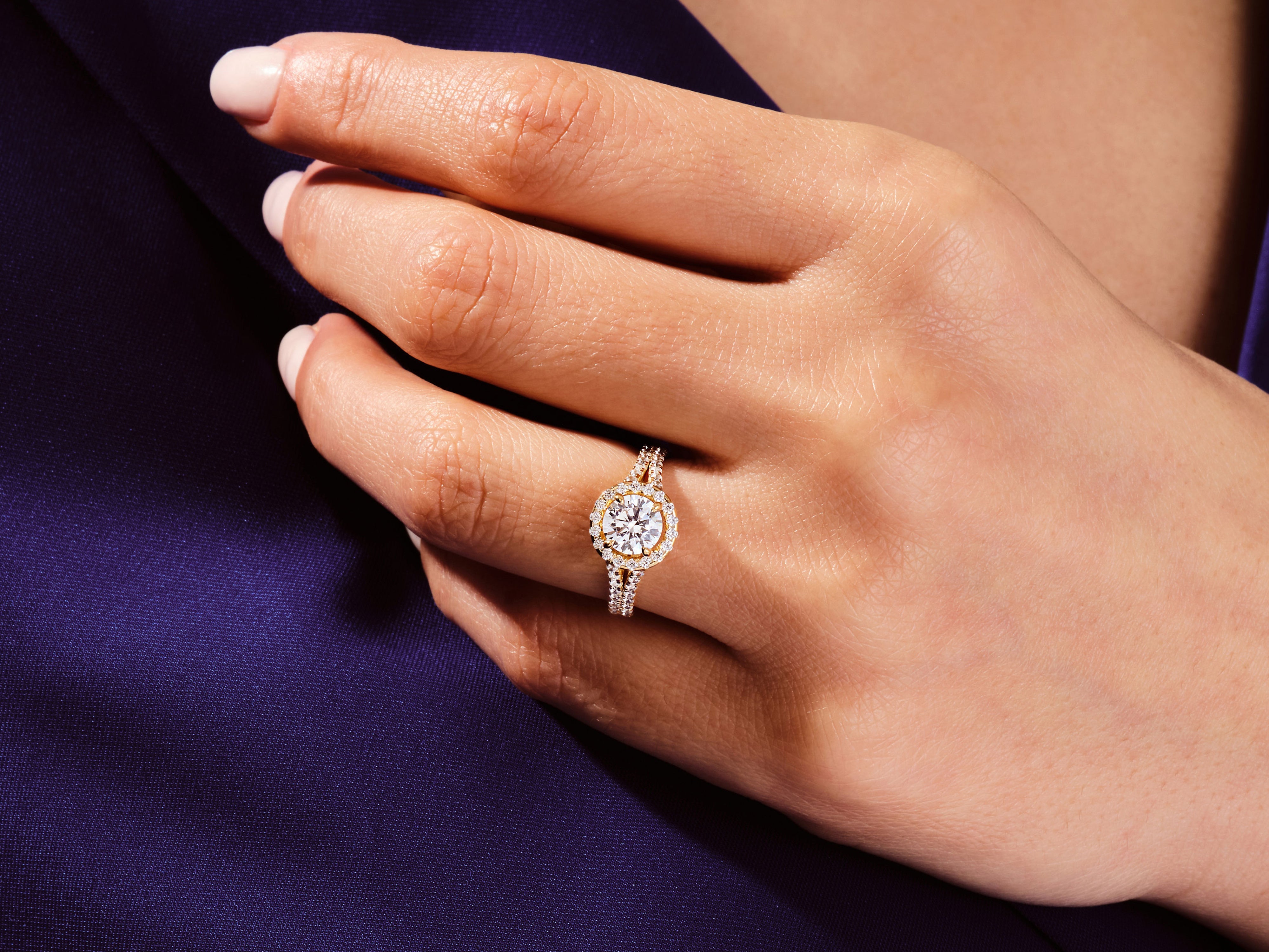 Diamond halo engagement ring on a woman's hand