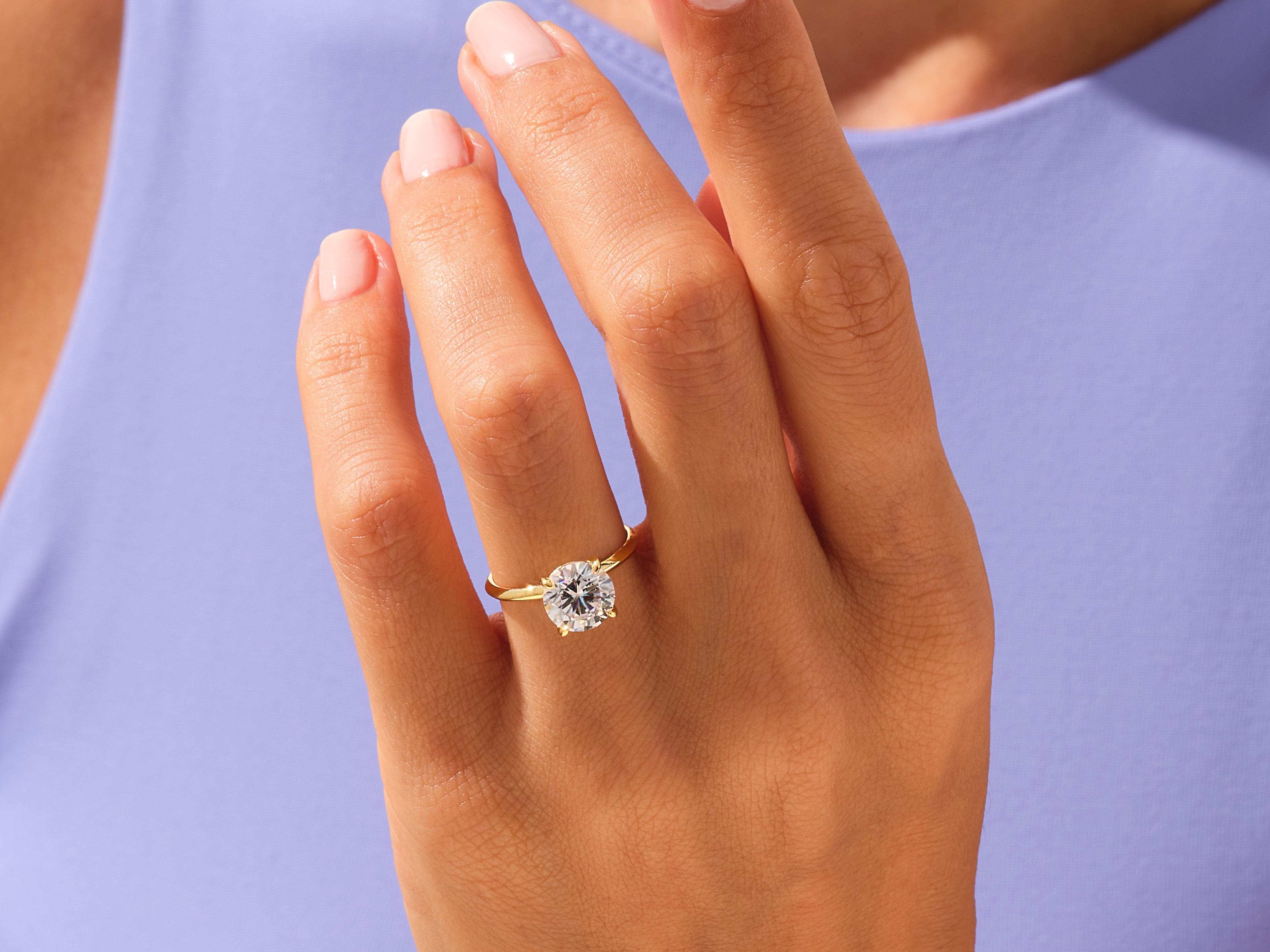 Gold diamond ring on a woman's hand, jewelry photography