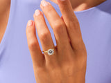 Gold solitaire ring with a large diamond on a woman's hand