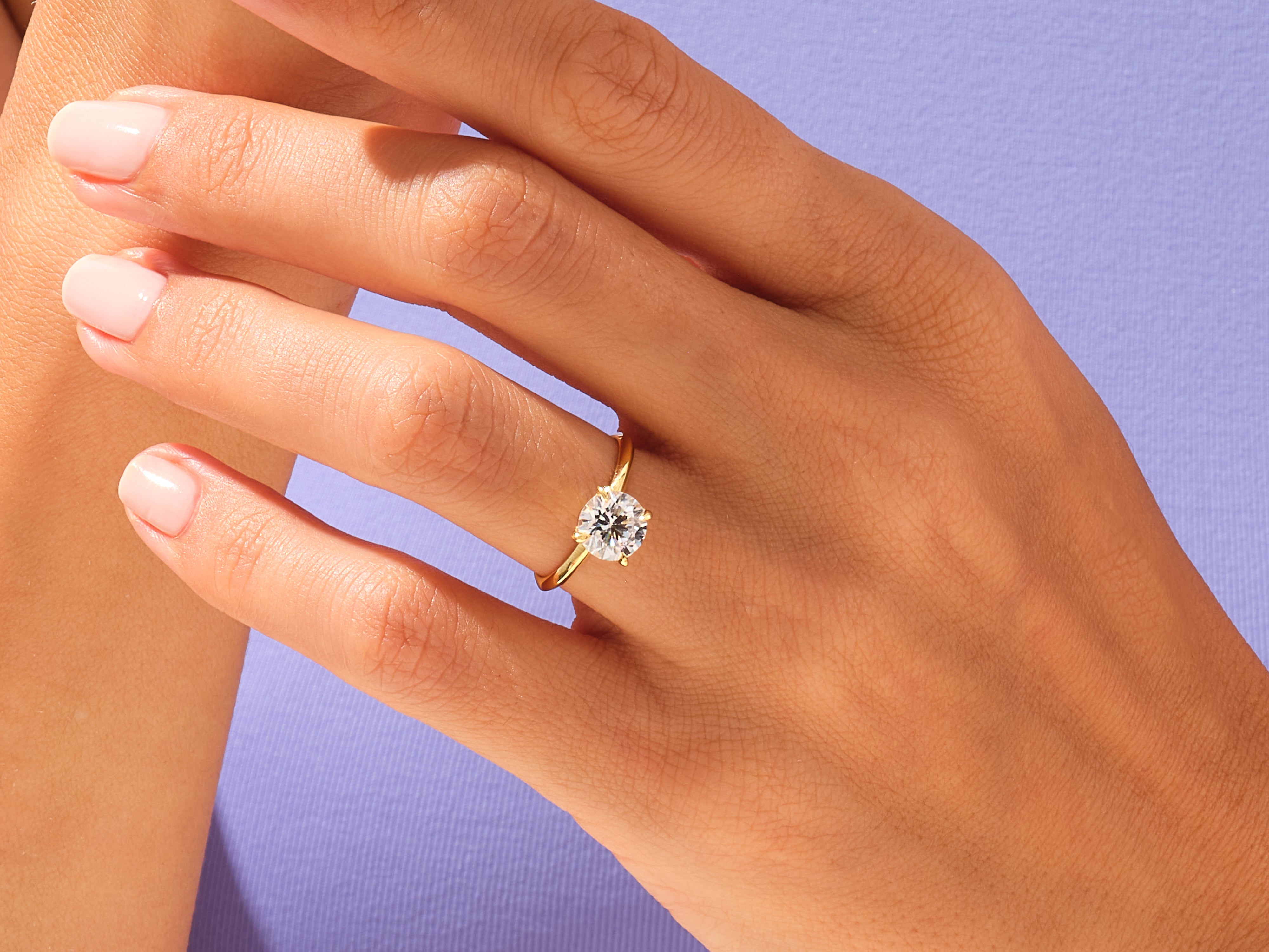 Gold diamond ring on a woman's hand, jewelry product photography