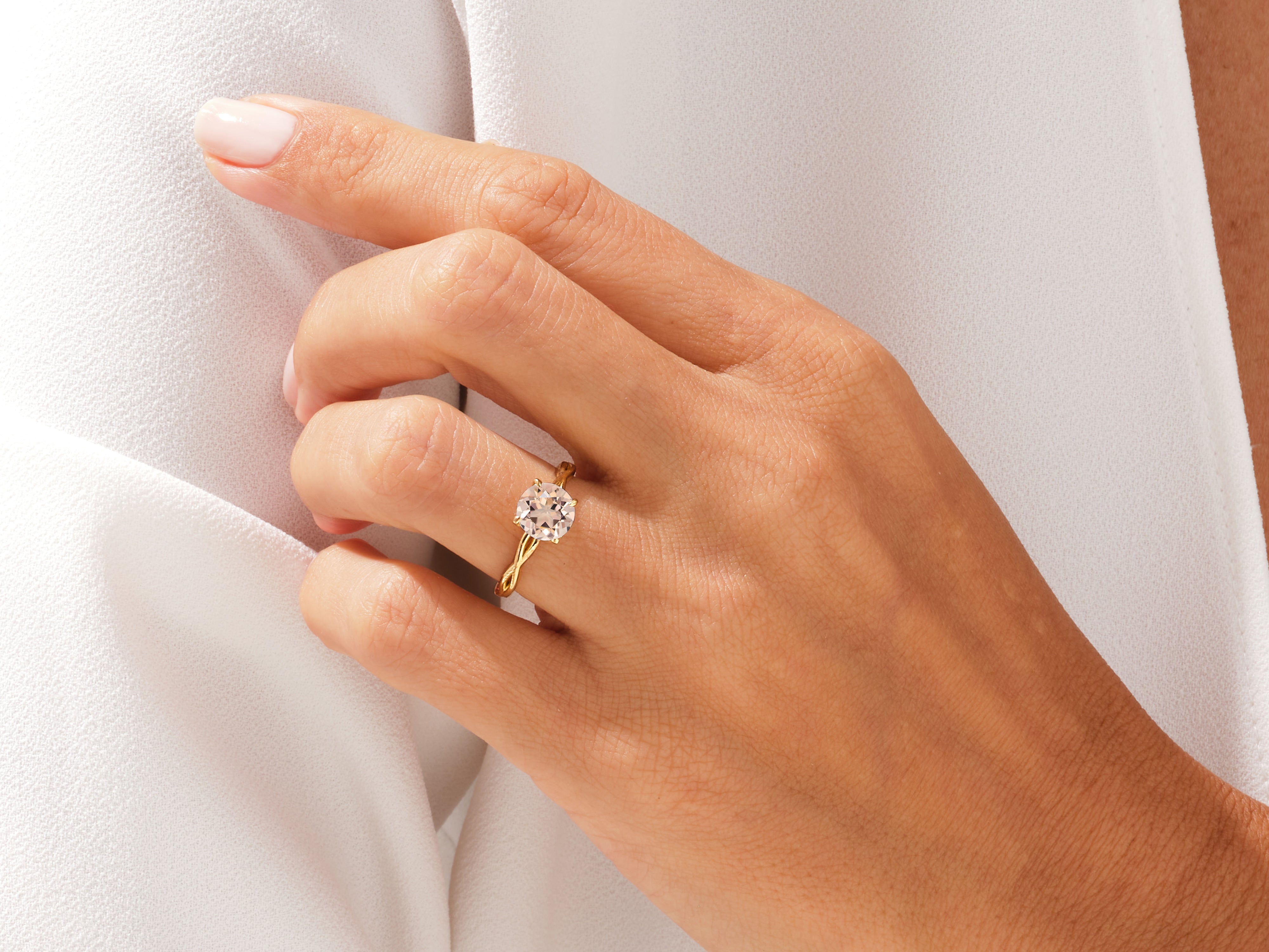 Gold engagement ring with diamond on a hand