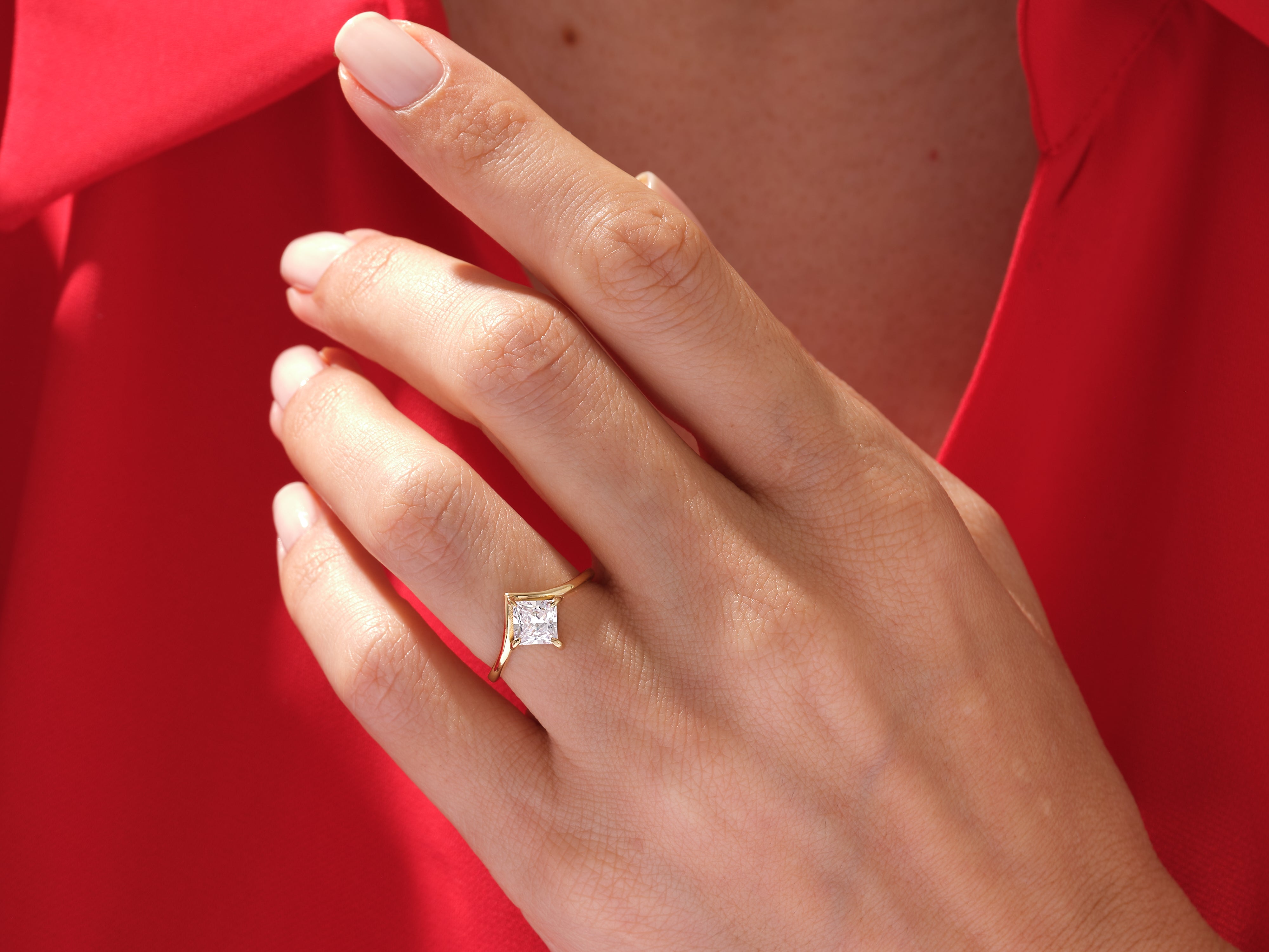 Gold princess cut diamond ring on hand