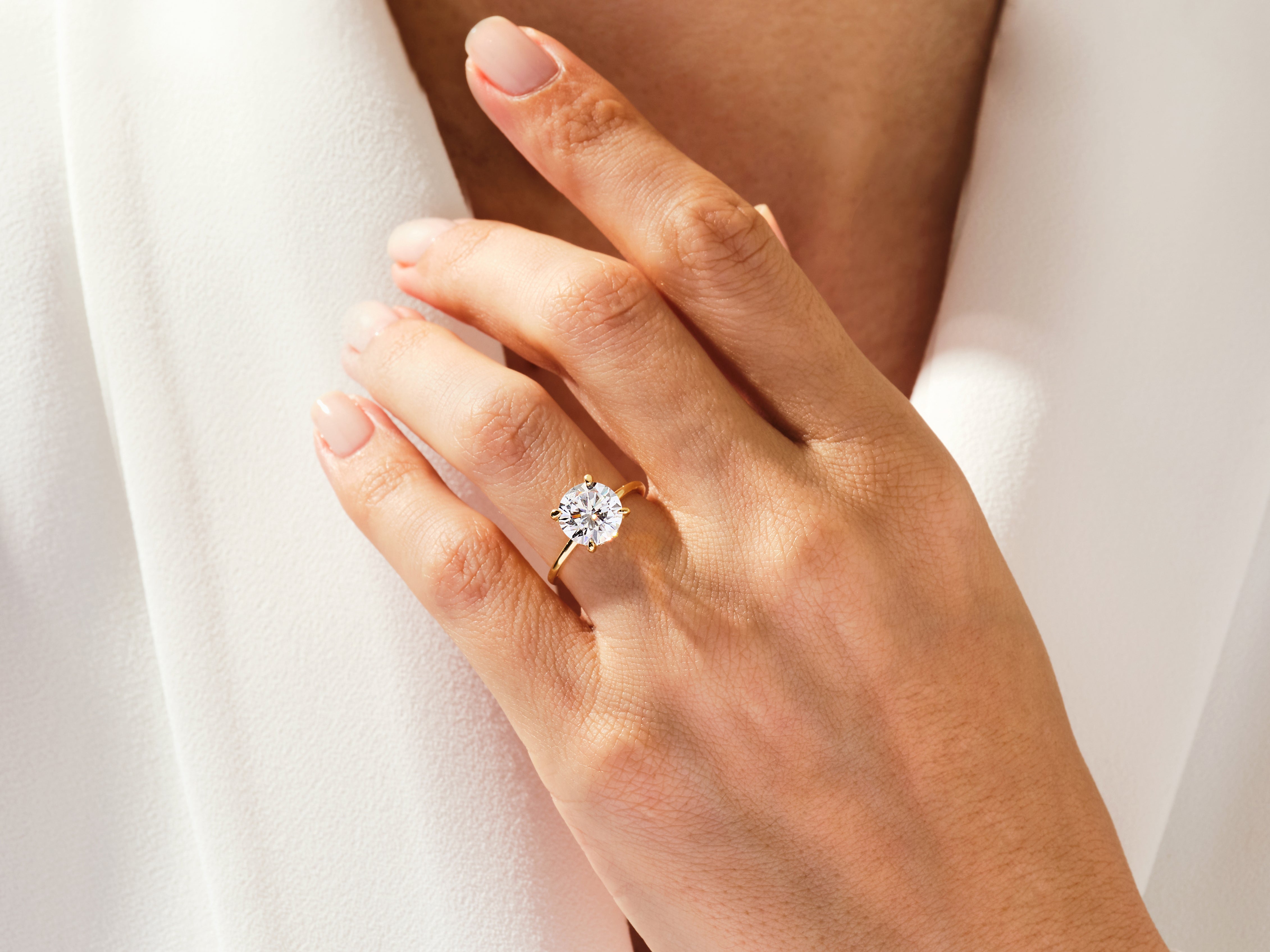 Diamond engagement ring on a woman's hand, jewelry photography