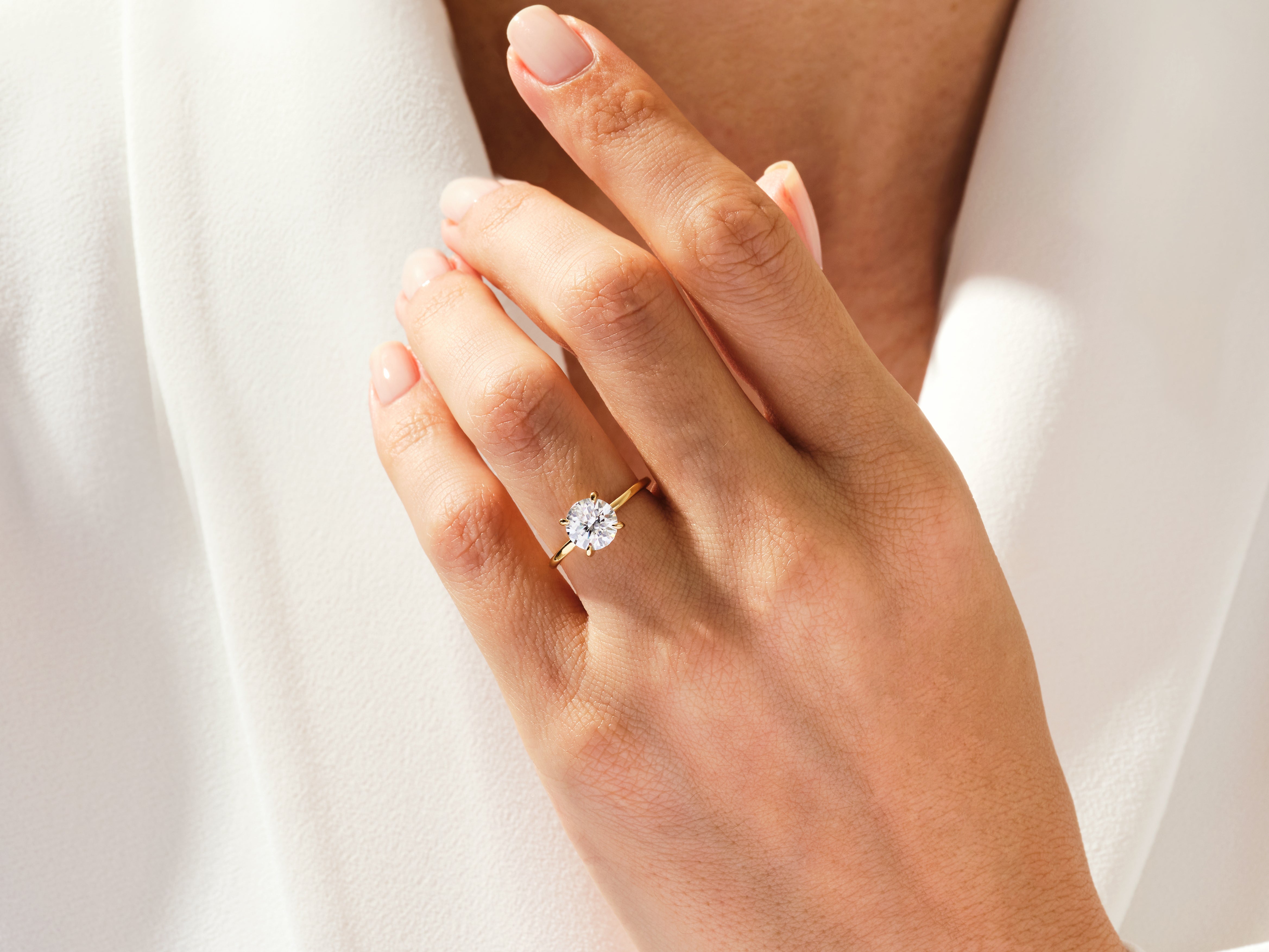Diamond engagement ring on a woman's hand, jewelry firm product