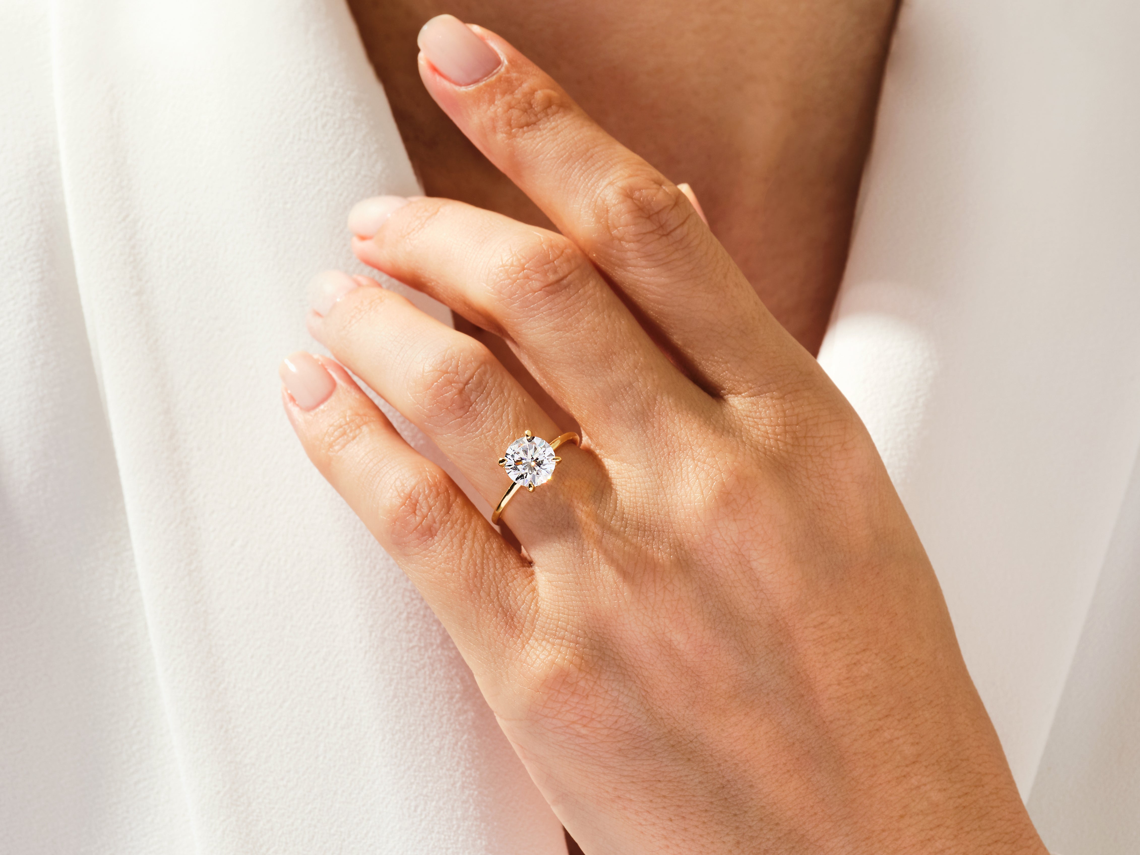 Diamond engagement ring on a woman's hand, jewelry product photography