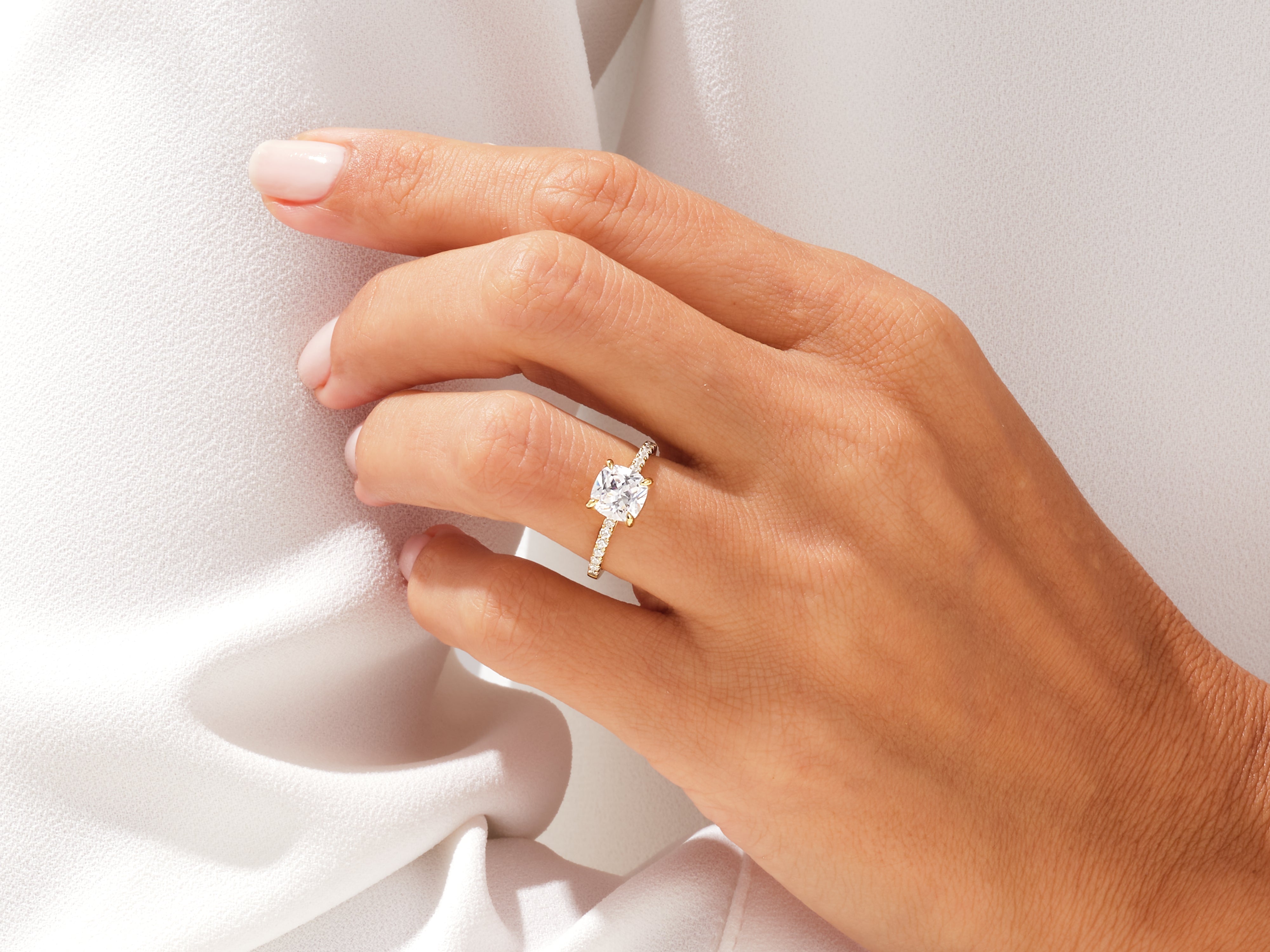 Diamond engagement ring on a hand, jewelry product photography