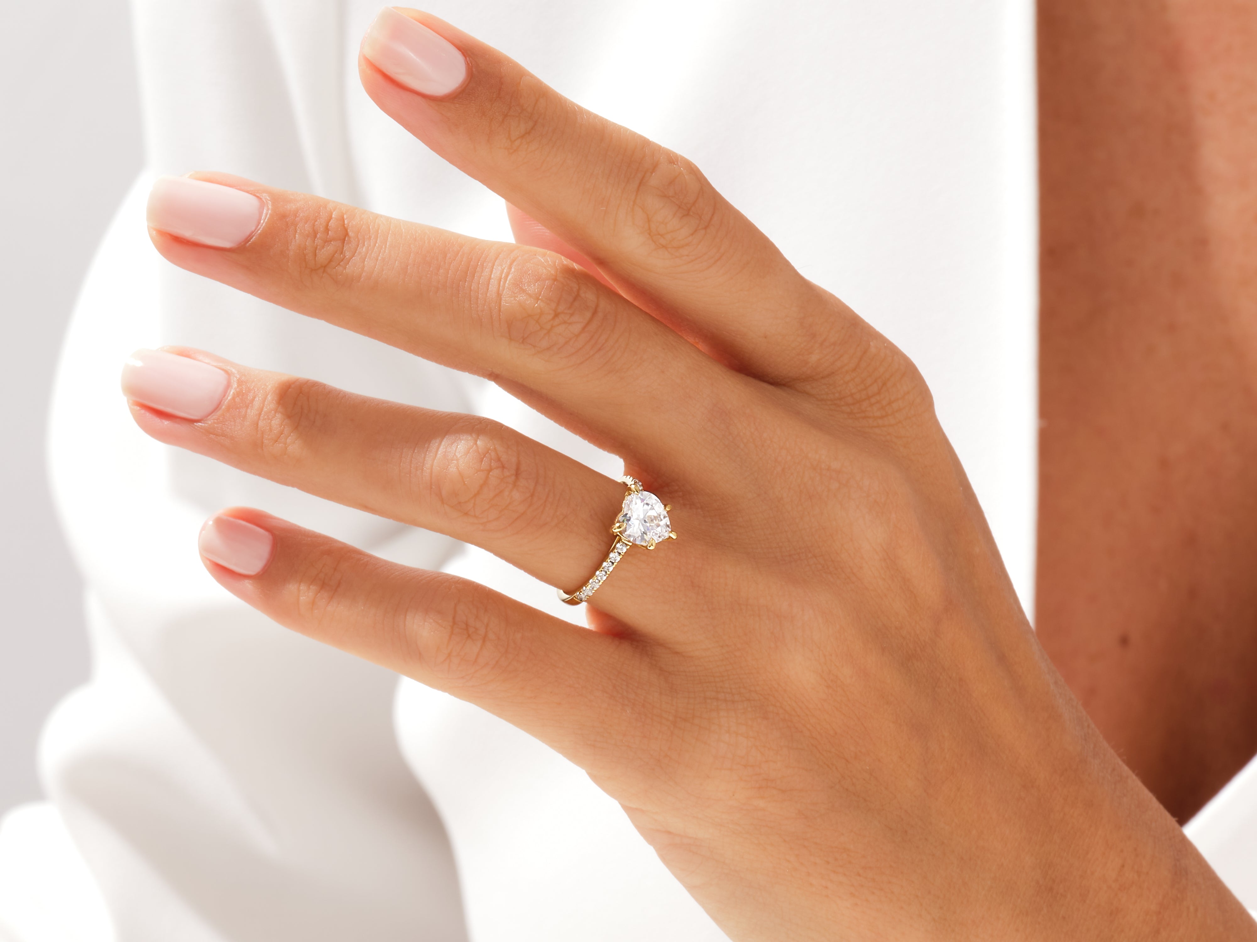 Gold heart diamond ring on a woman's hand