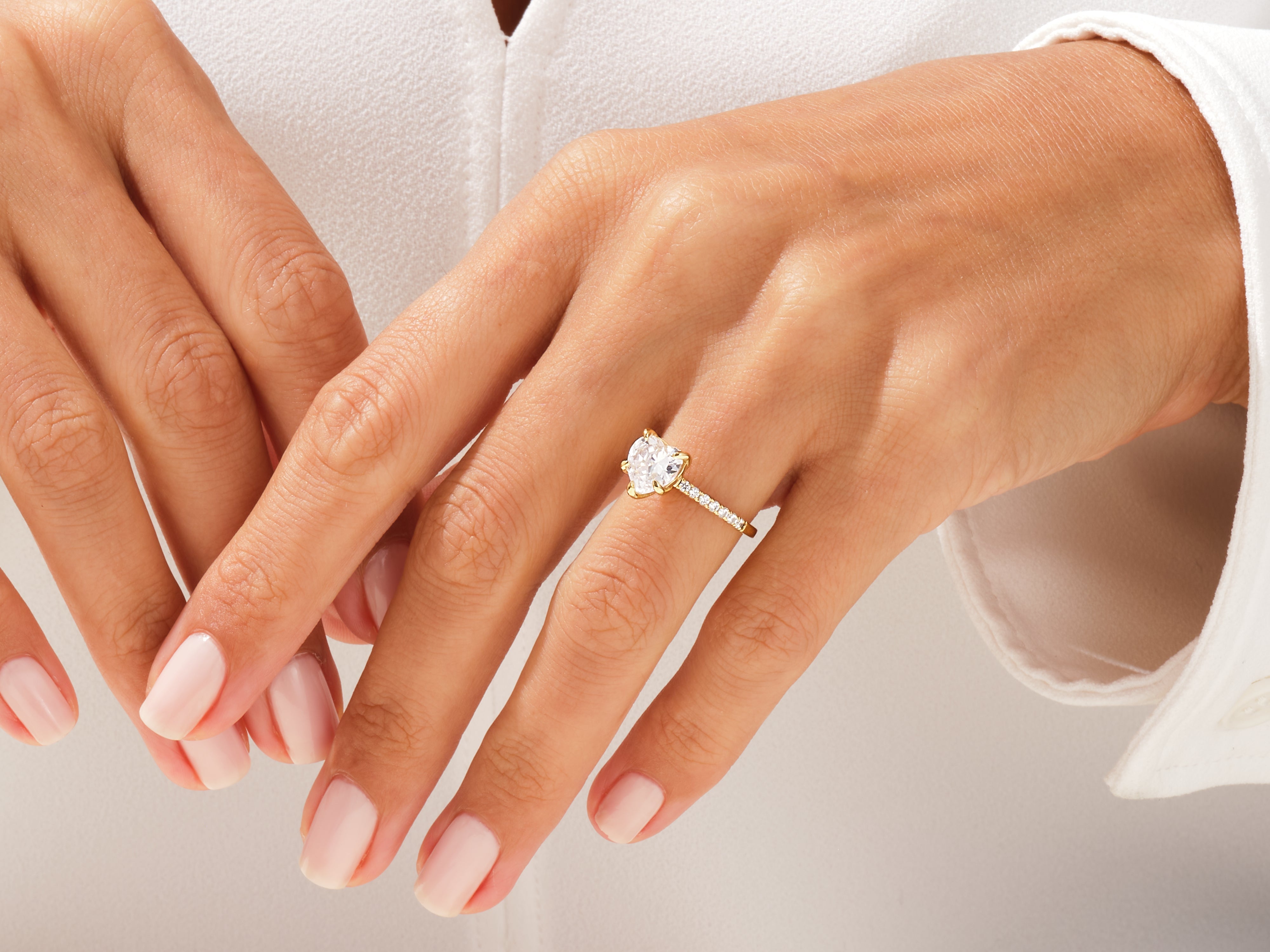 Diamond heart engagement ring on a woman's hand