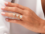 Three diamond halo engagement rings on a hand