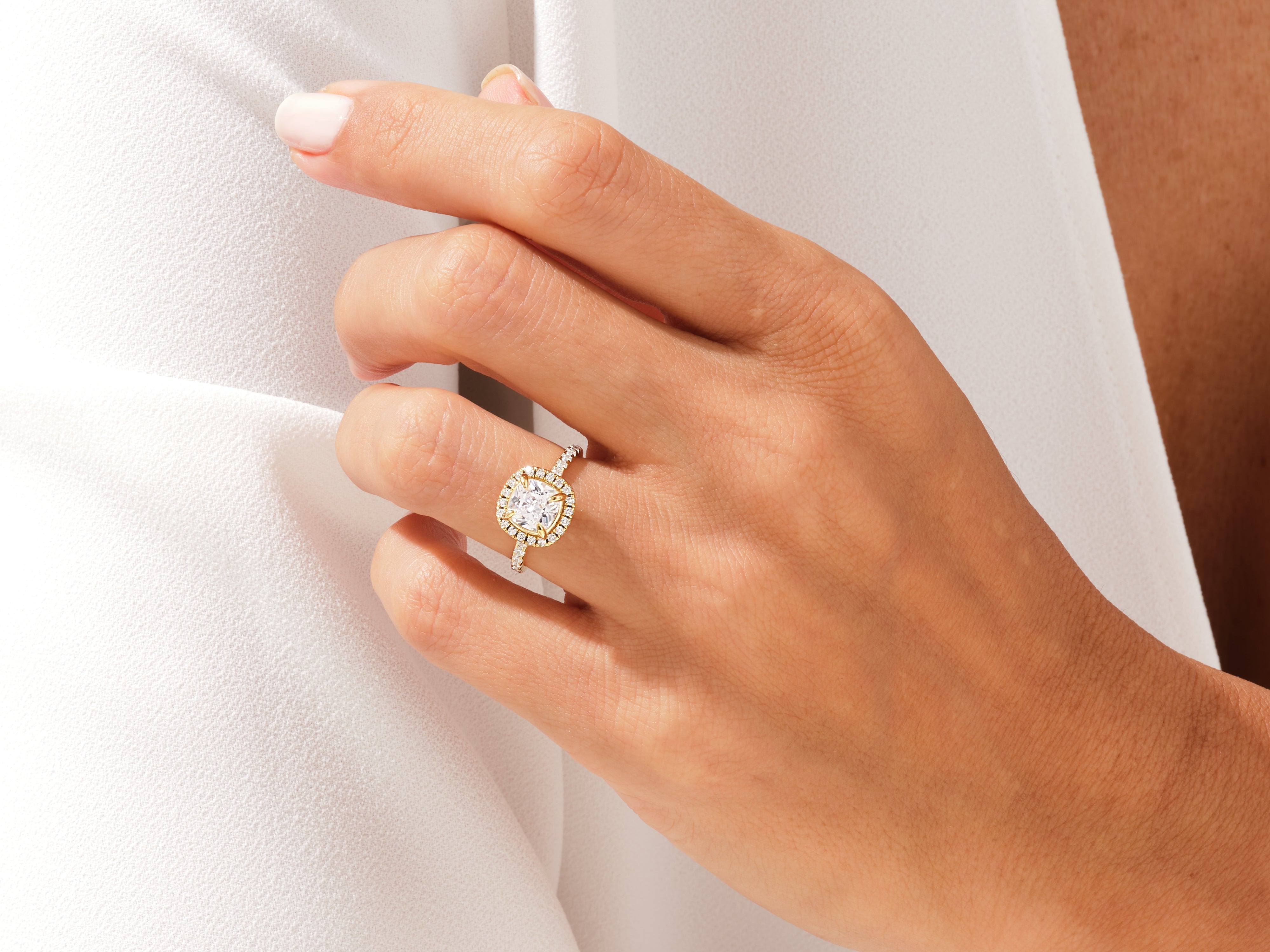 Diamond halo engagement ring on a hand, jewelry