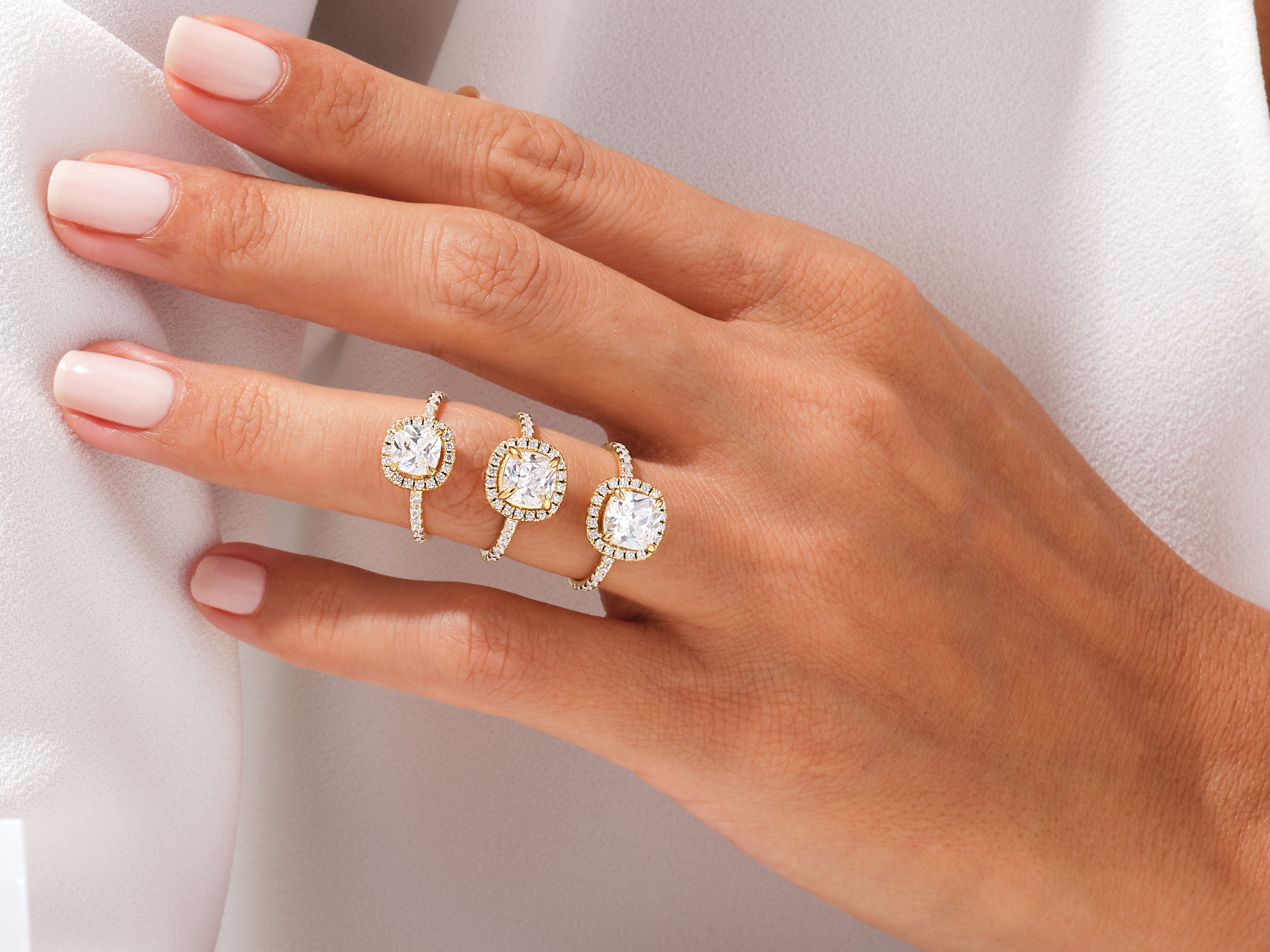 Diamond halo rings on a hand, jewelry photography