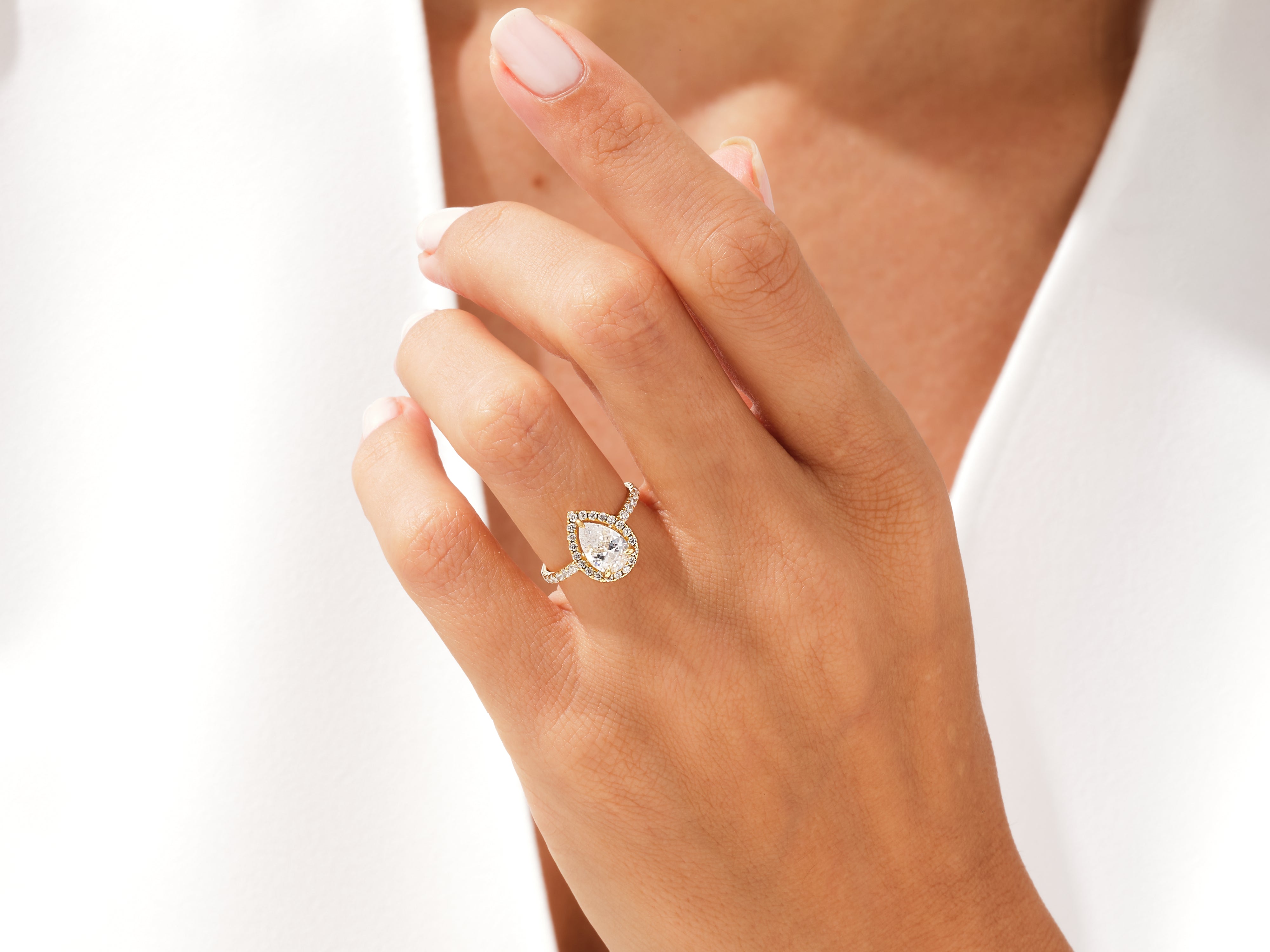 Pear-shaped diamond engagement ring with halo, fine jewelry