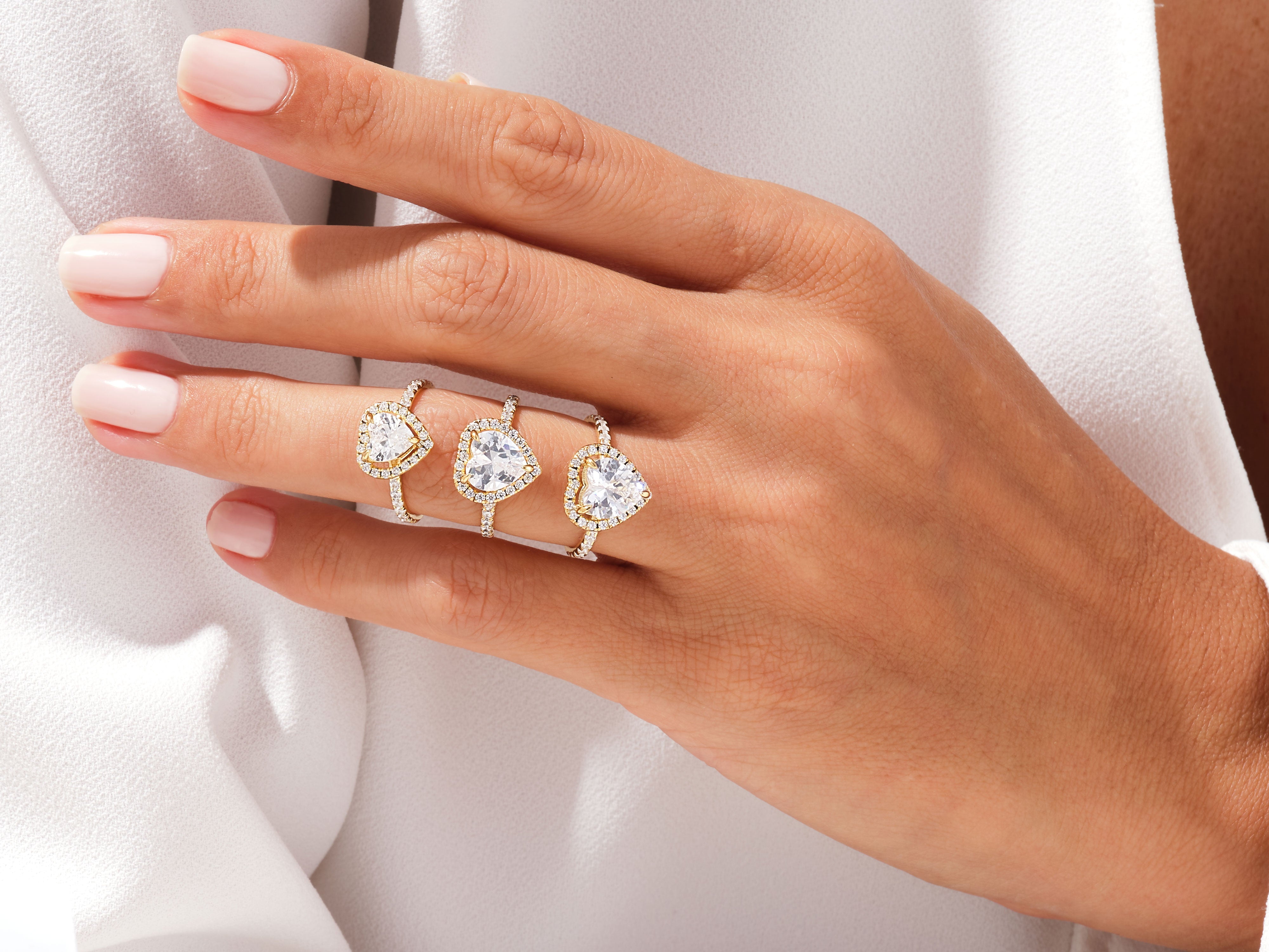 Diamond heart rings on a hand, fine jewelry collection