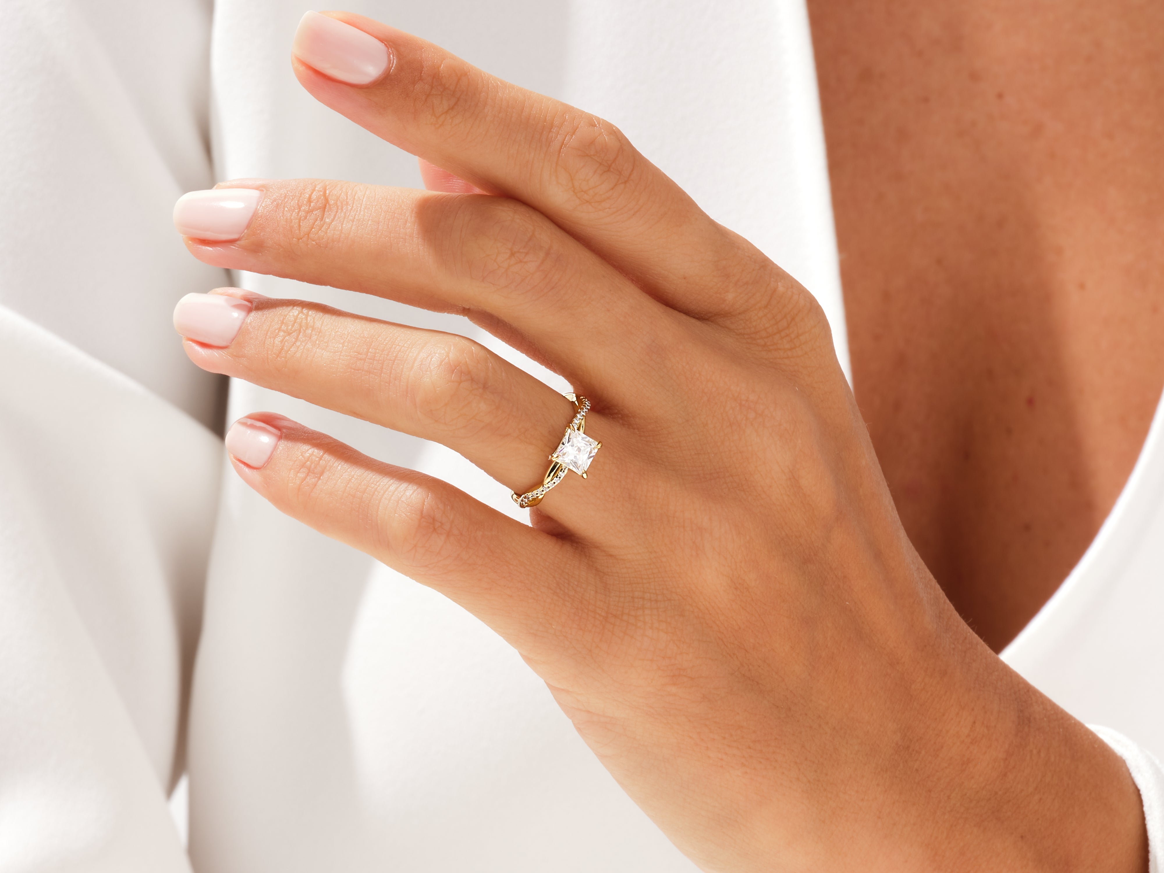Gold princess cut diamond engagement ring on hand