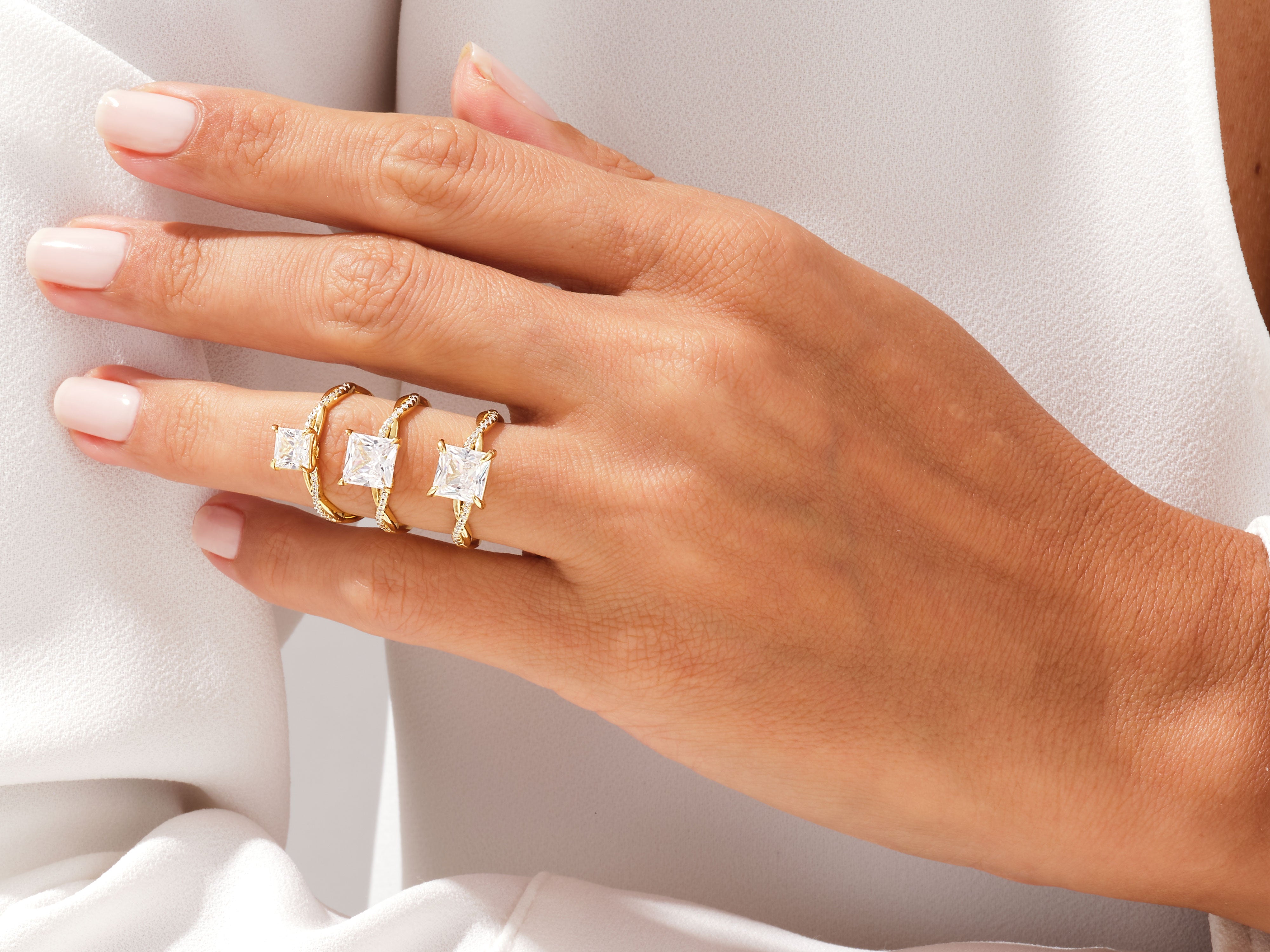 Diamond engagement rings on a hand, jewelry collection