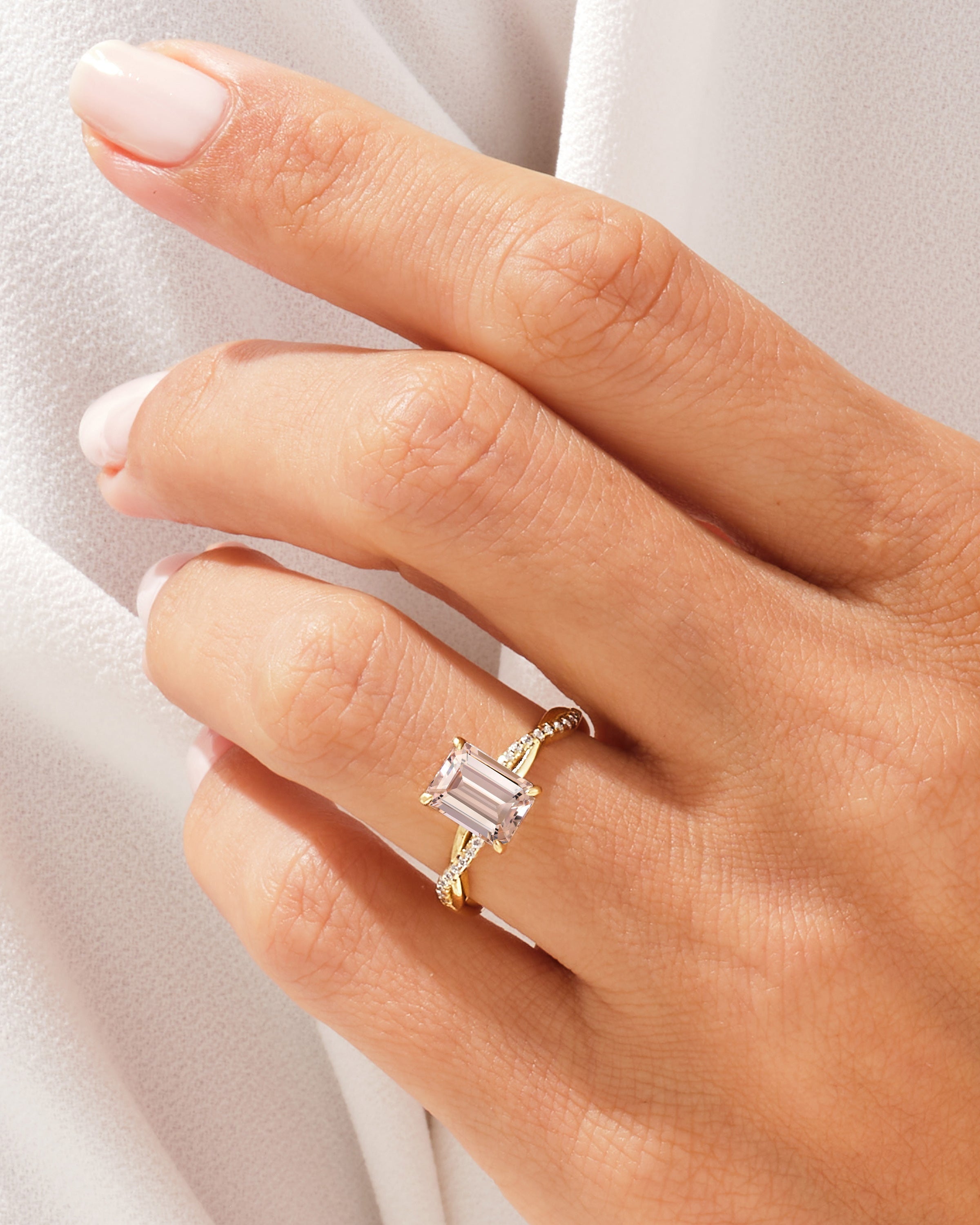 Emerald cut diamond ring with pave band on hand