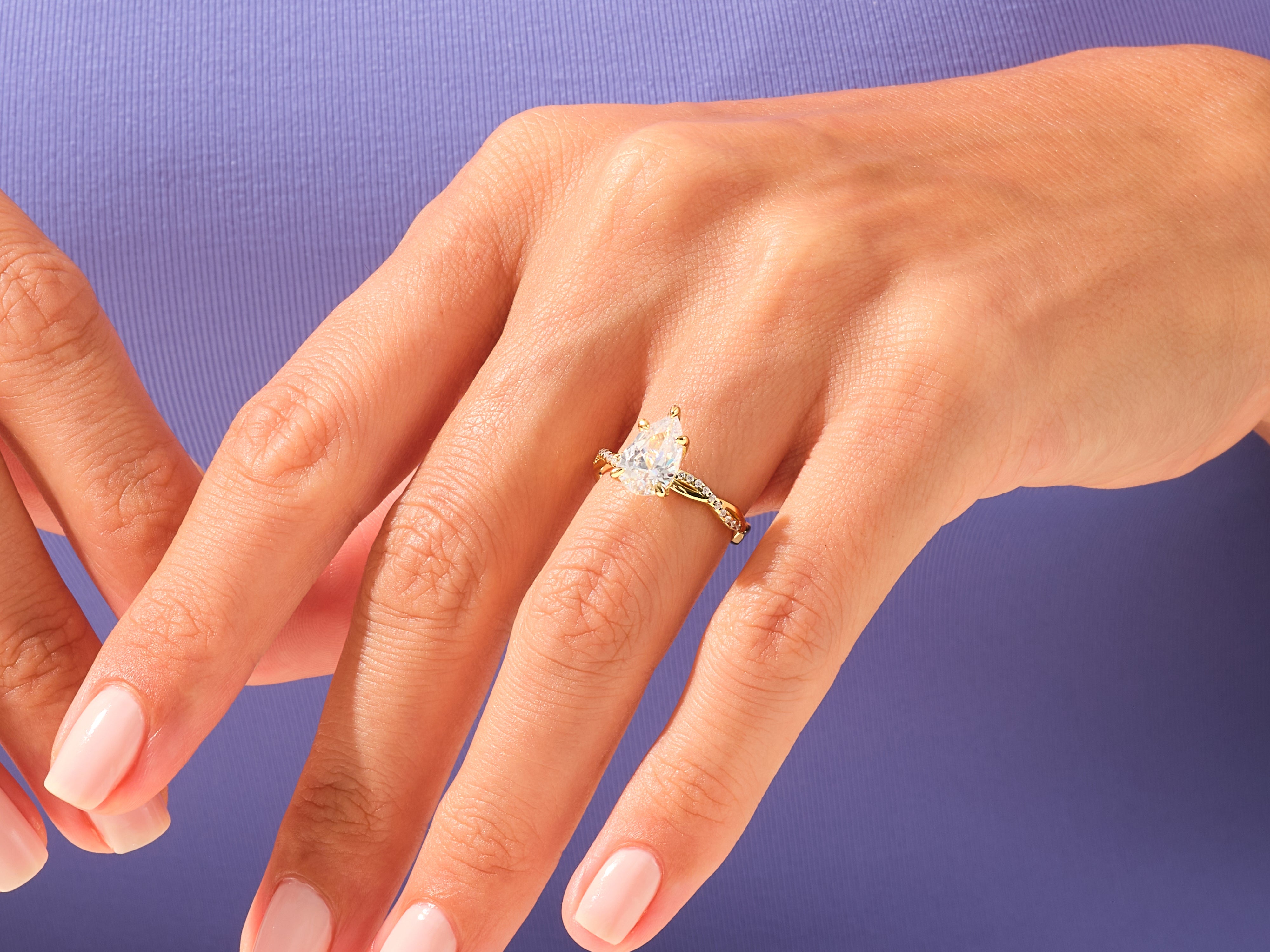 Pear-shaped diamond engagement ring on a woman's hand