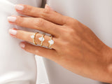 Gold pear-shaped diamond rings on a hand