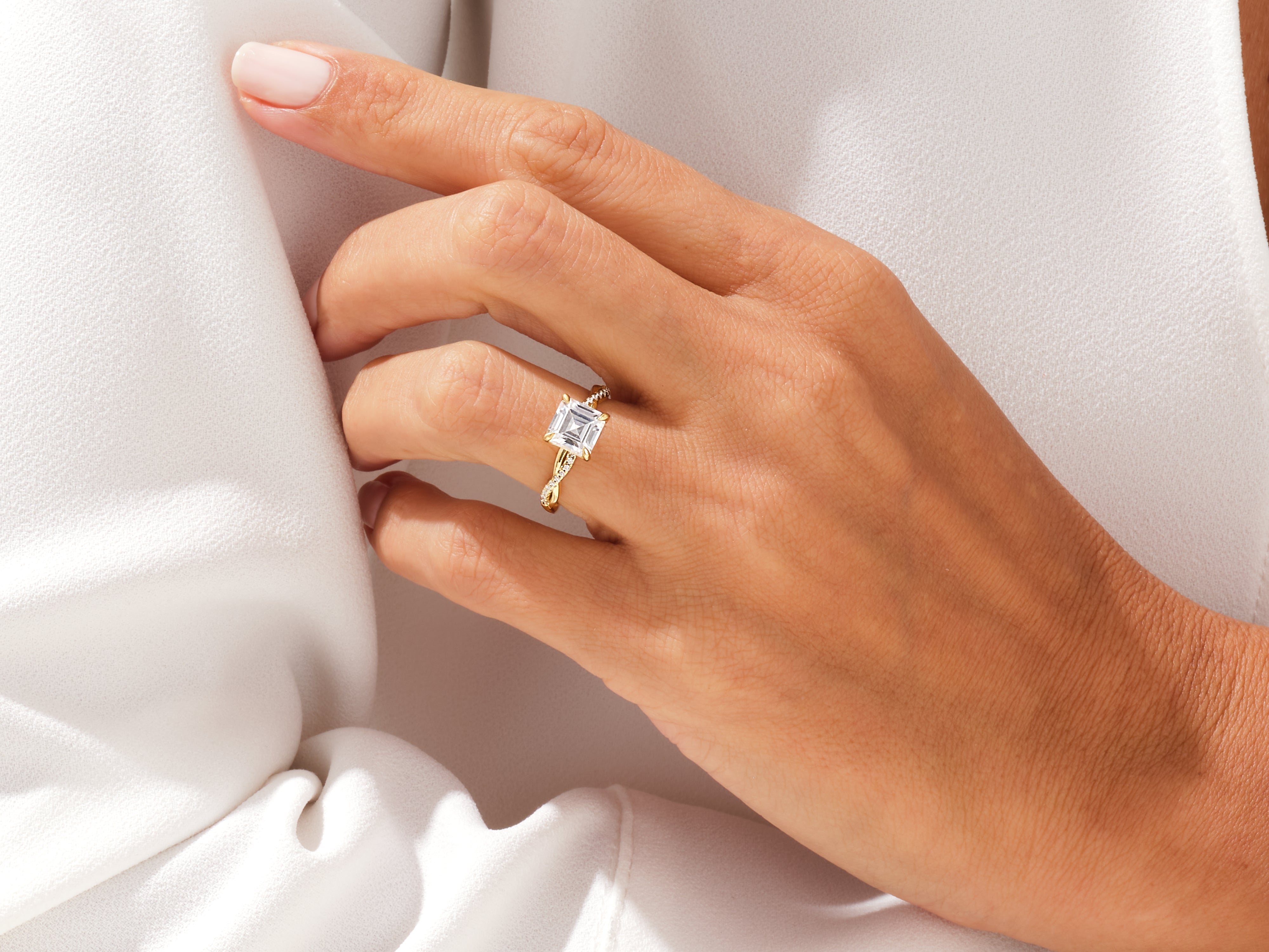 Elegant gold ring with princess-cut diamond on hand