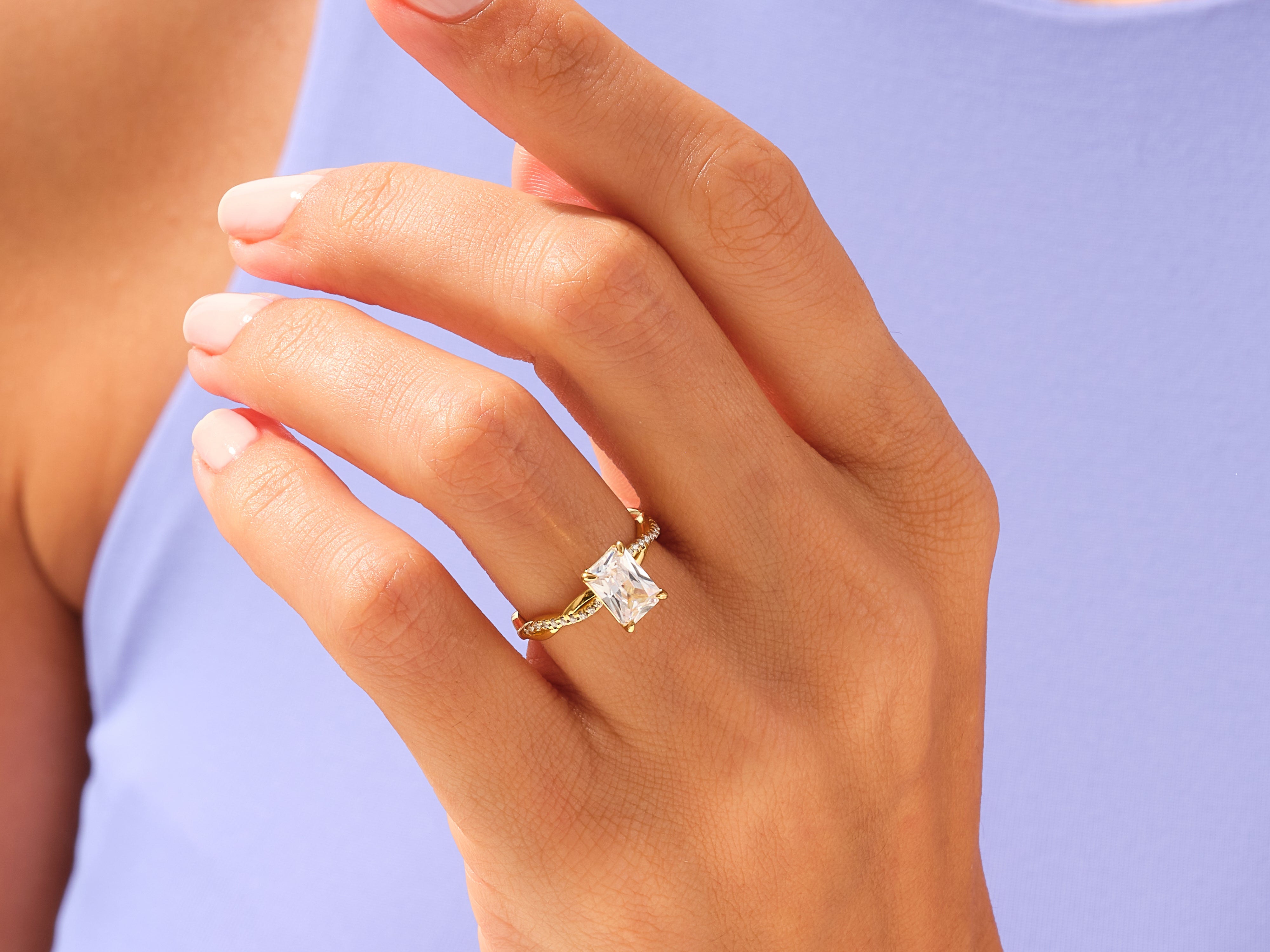 Gold ring with princess cut diamond on hand