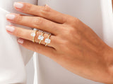 Three elegant gold rings with baguette diamonds on a hand