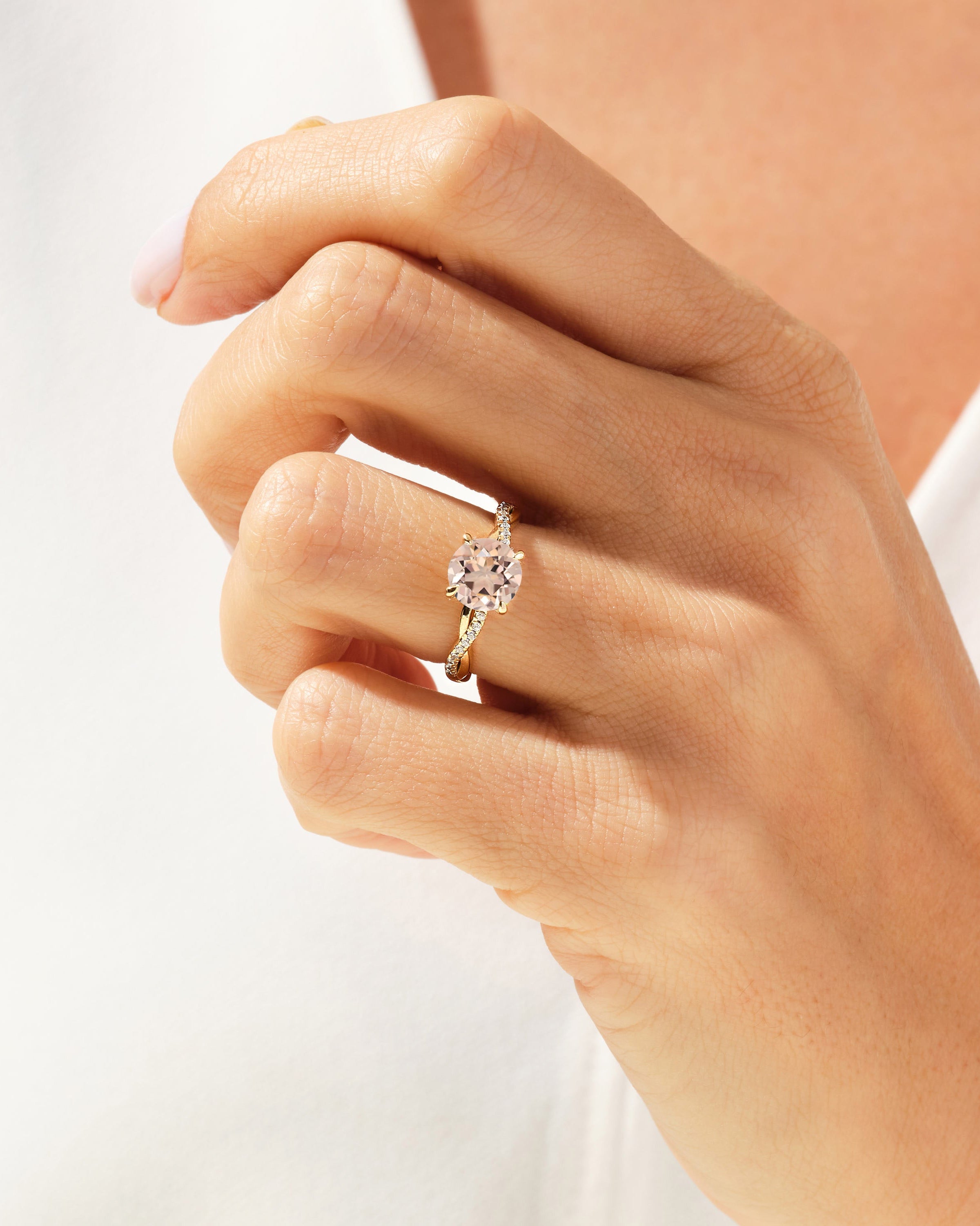 Elegant gold ring with diamond band and pink gemstone