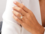 Gold diamond halo square engagement ring on hand