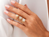Gold diamond halo rings on a hand
