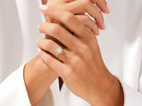Heart-shaped diamond engagement ring on a woman's hand