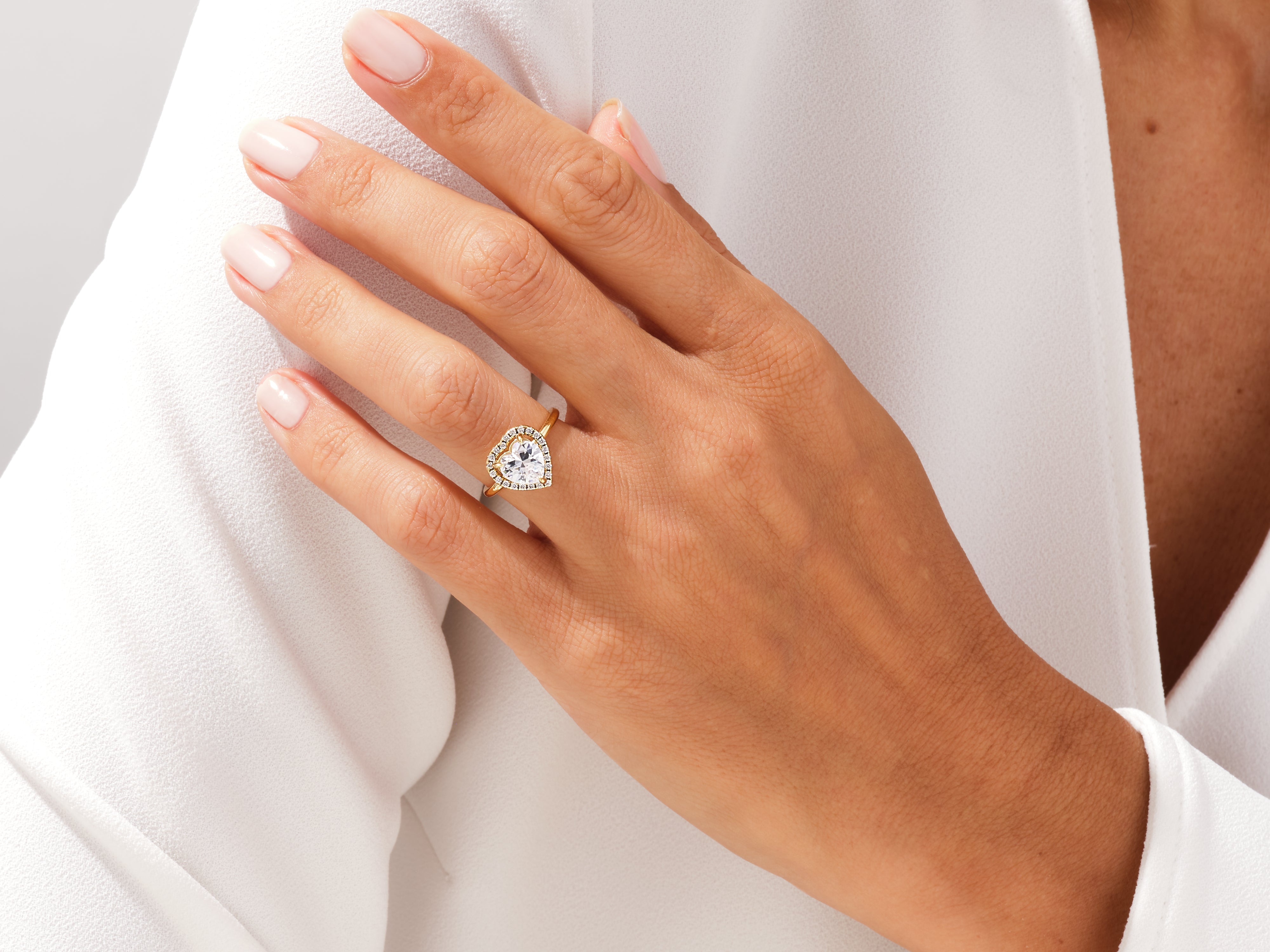 Heart-shaped diamond engagement ring on a woman's hand