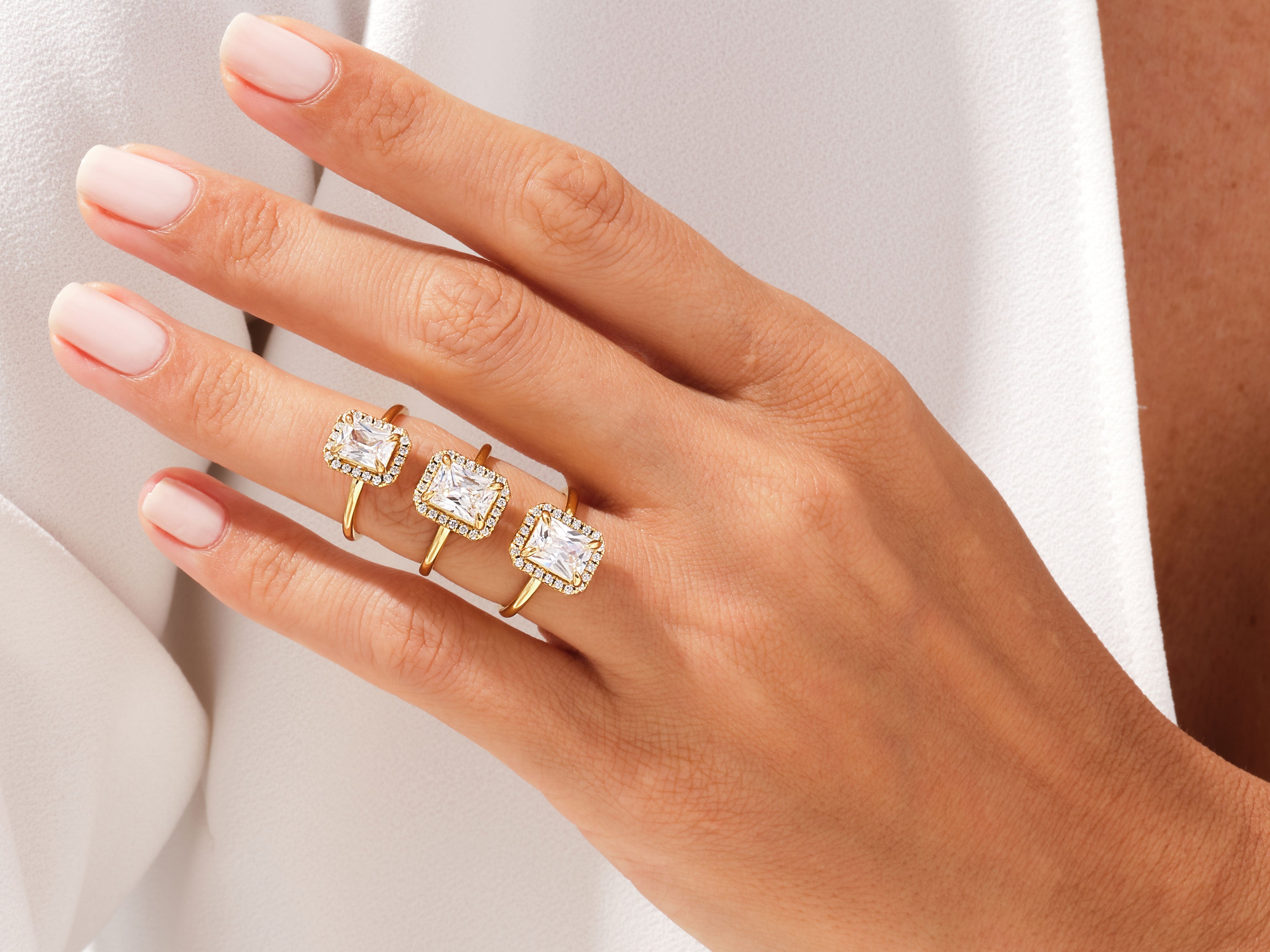 Gold rings with square cut diamonds on a hand