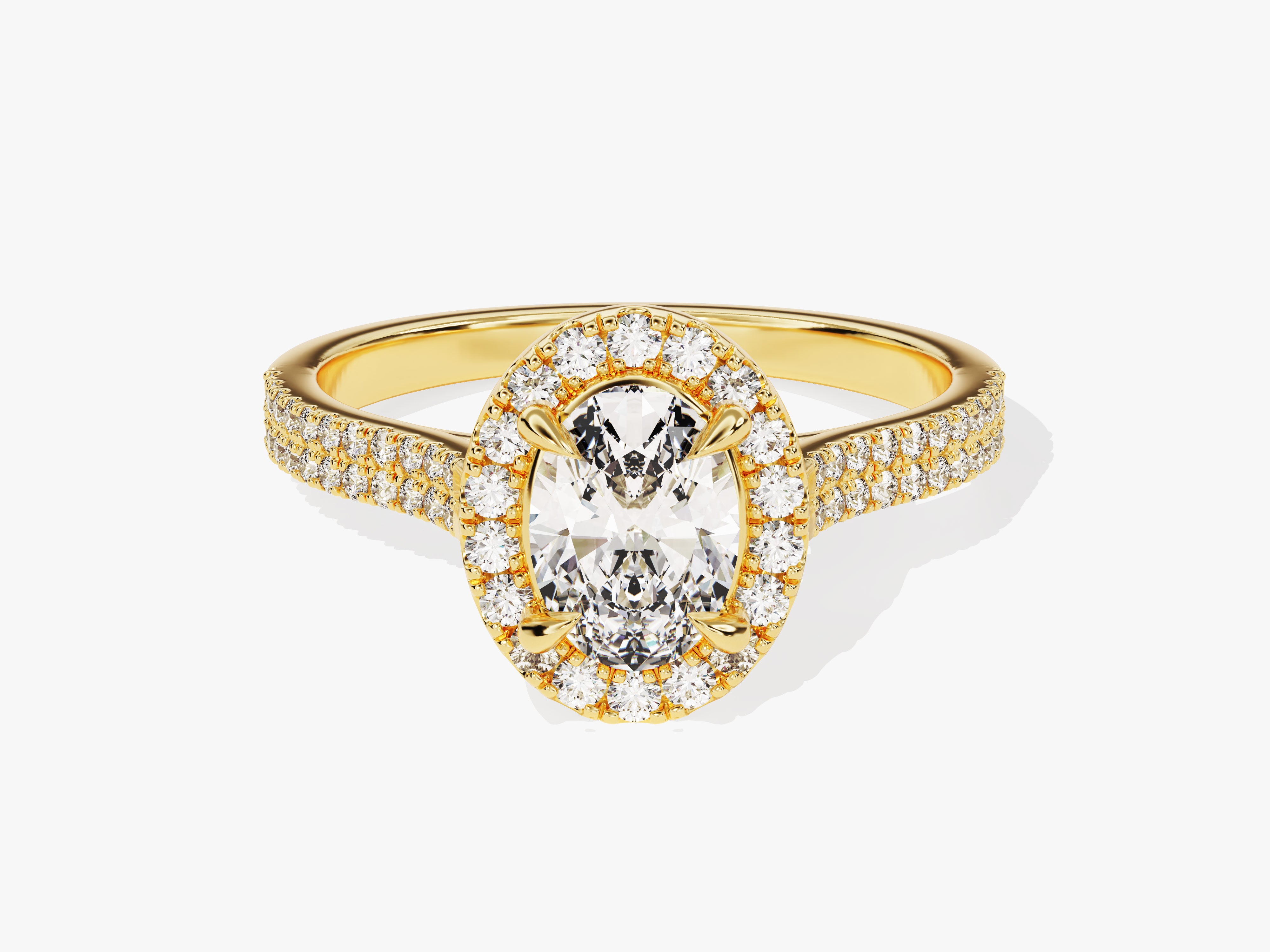 Oval diamond halo engagement ring in yellow gold