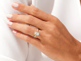 Oval diamond halo engagement ring in yellow gold