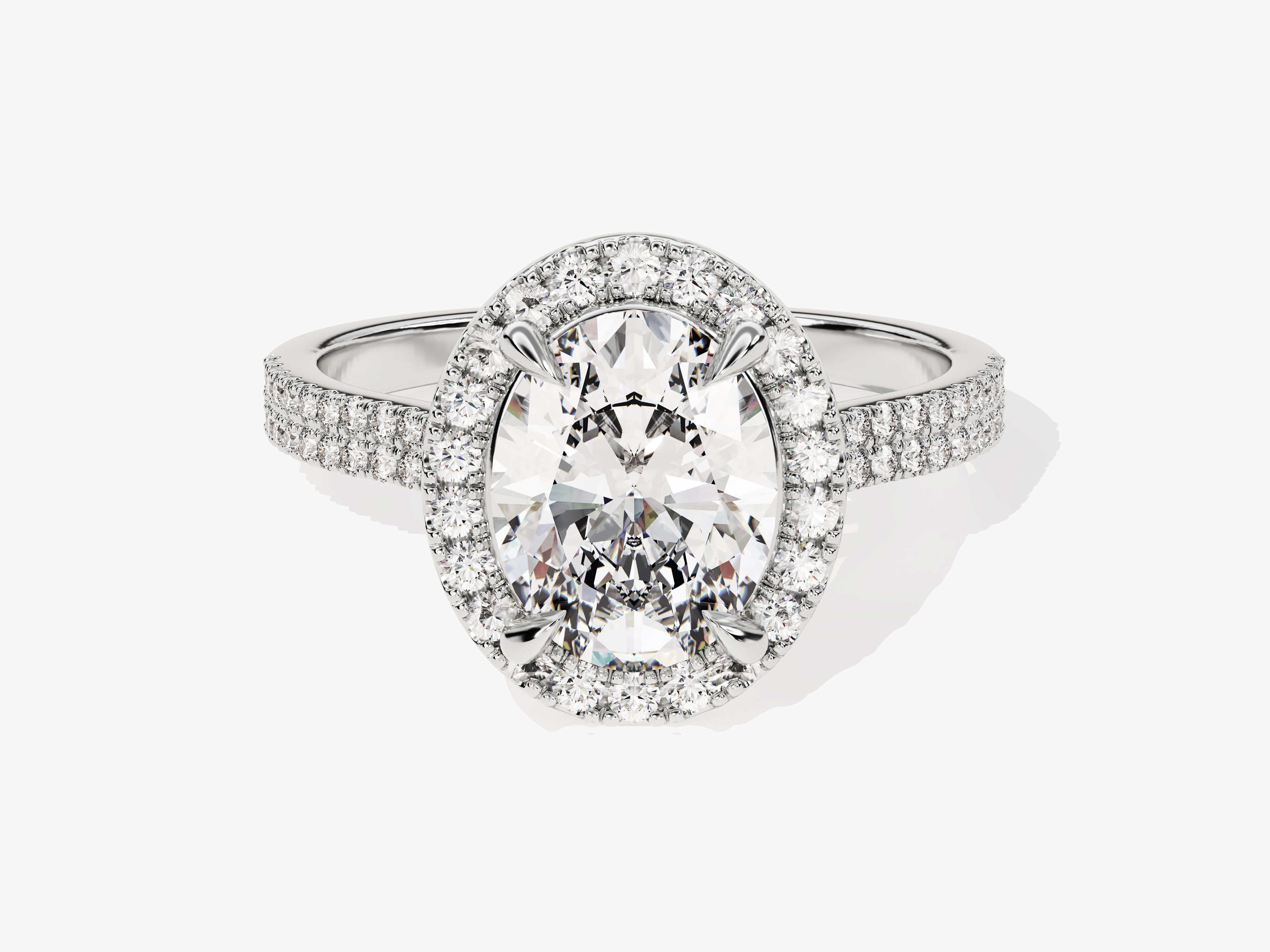 Oval diamond halo engagement ring with pave band