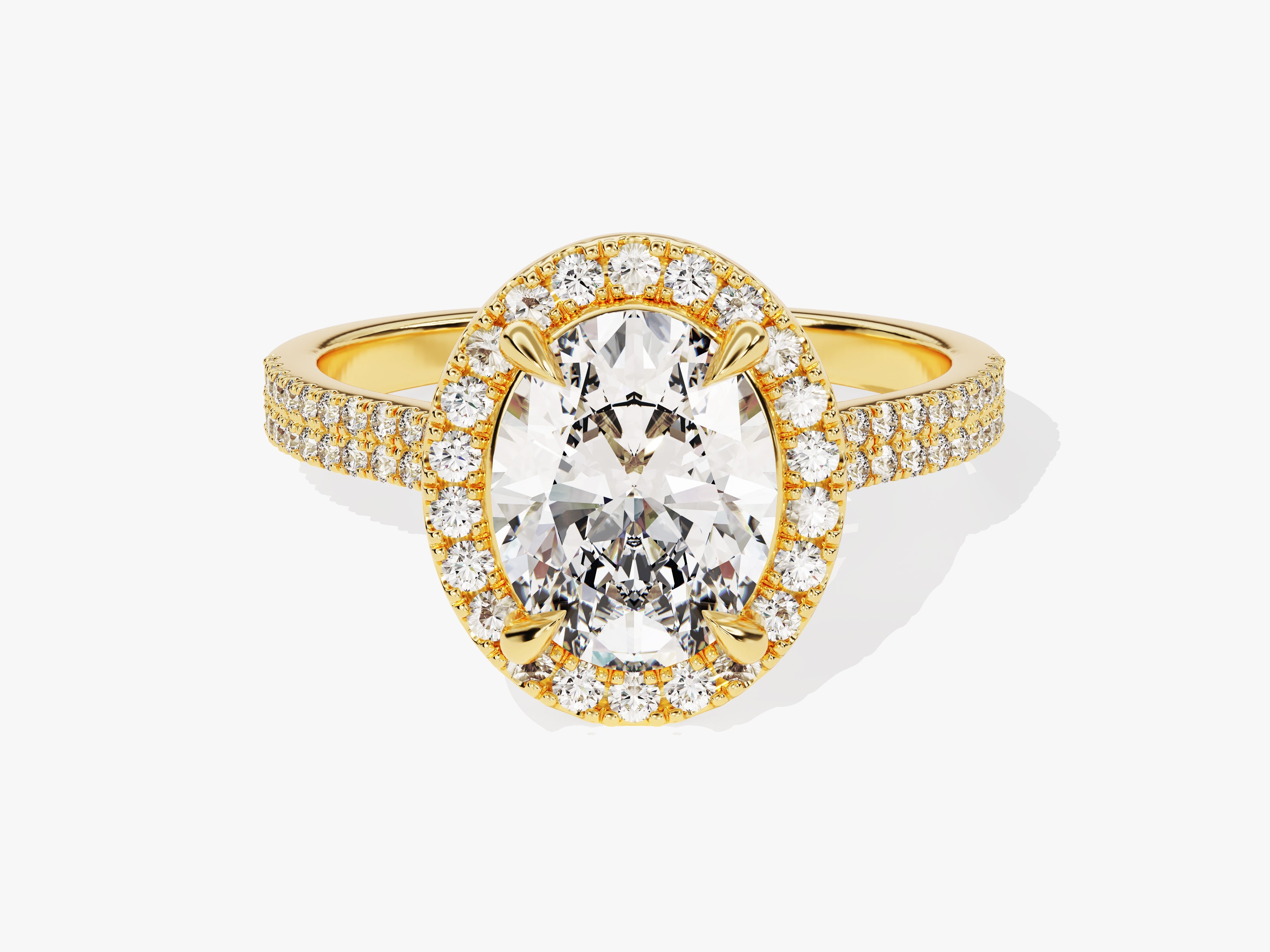 Oval diamond halo engagement ring in yellow gold