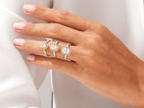 Three gold diamond halo rings on a hand
