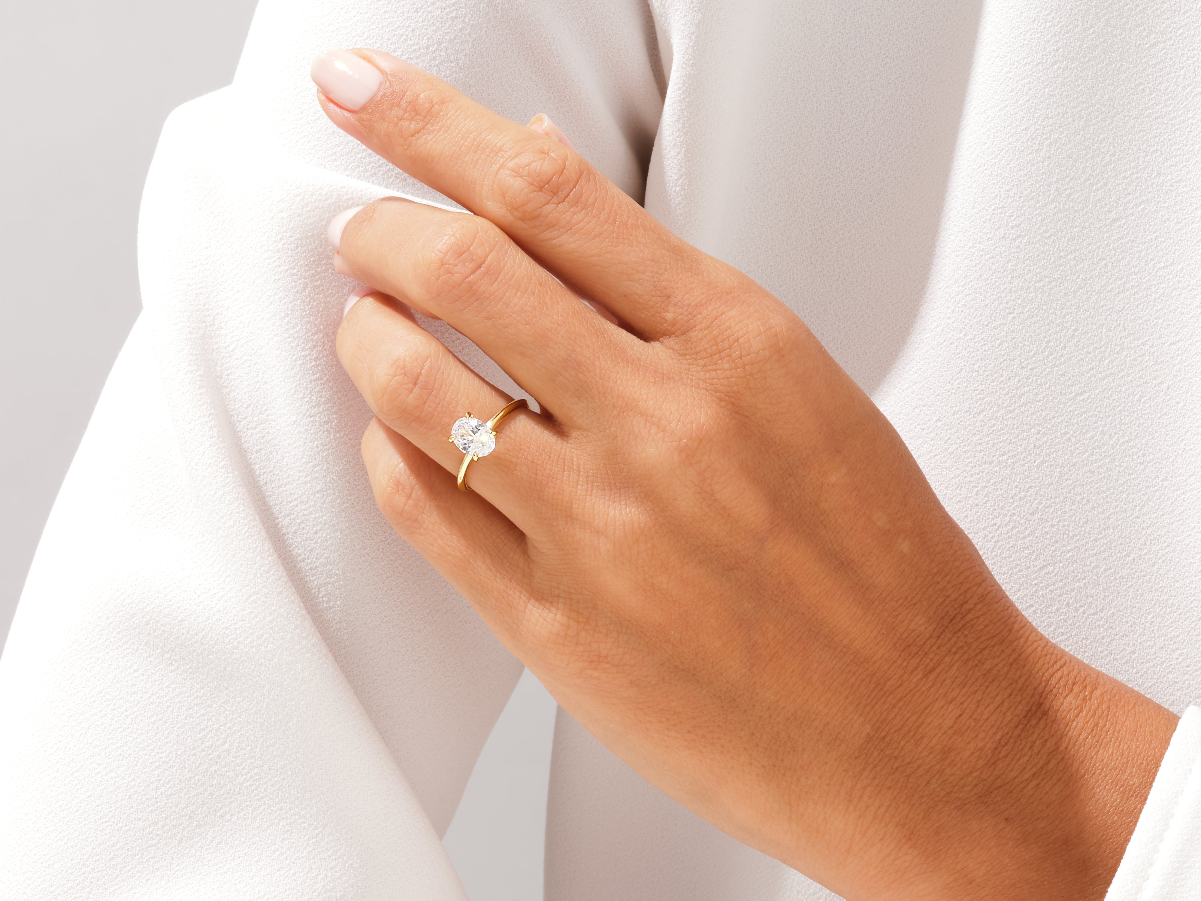 Oval diamond engagement ring on a woman's hand